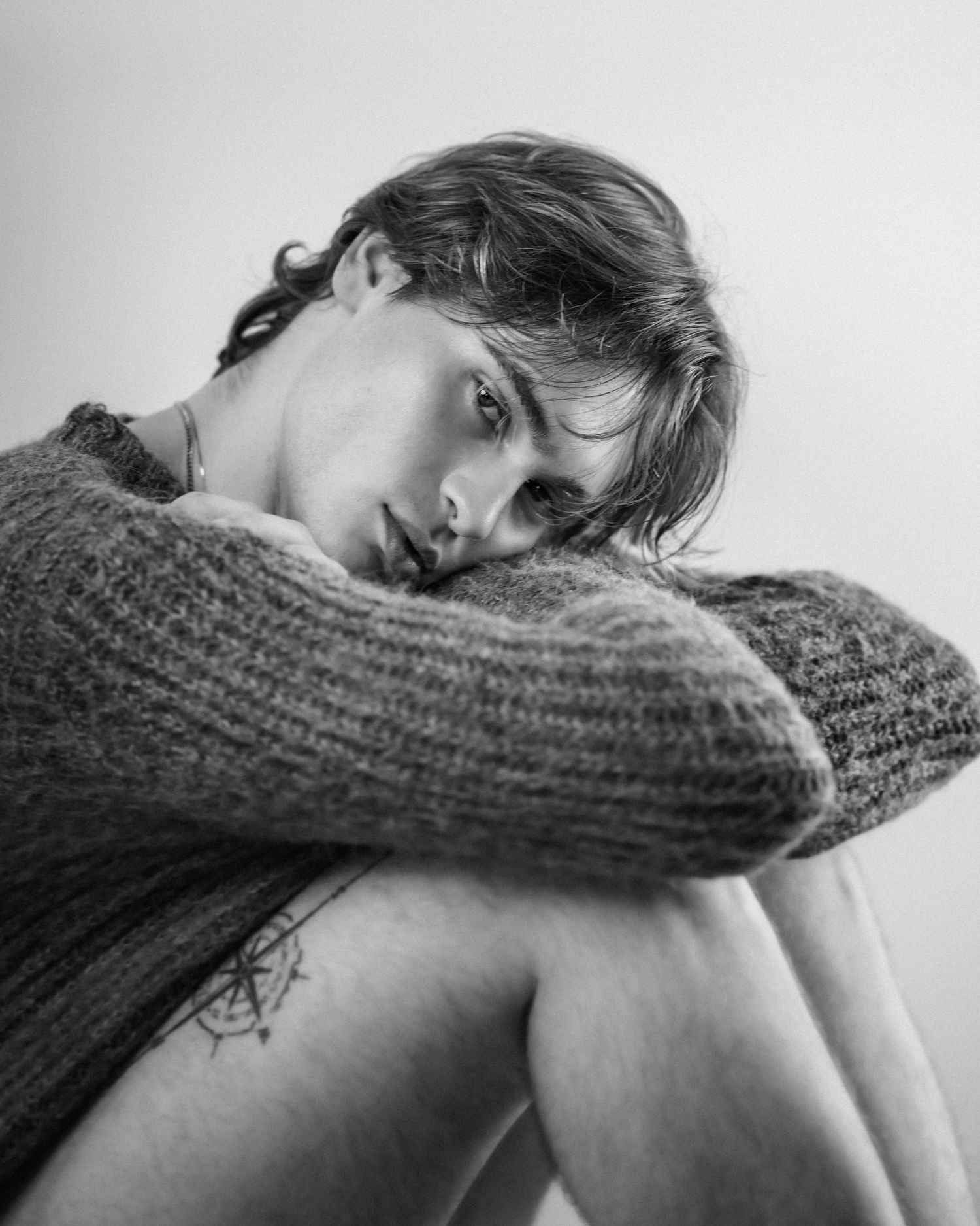 Intimate black and white portraits showing contemplative poses with knit sweater.