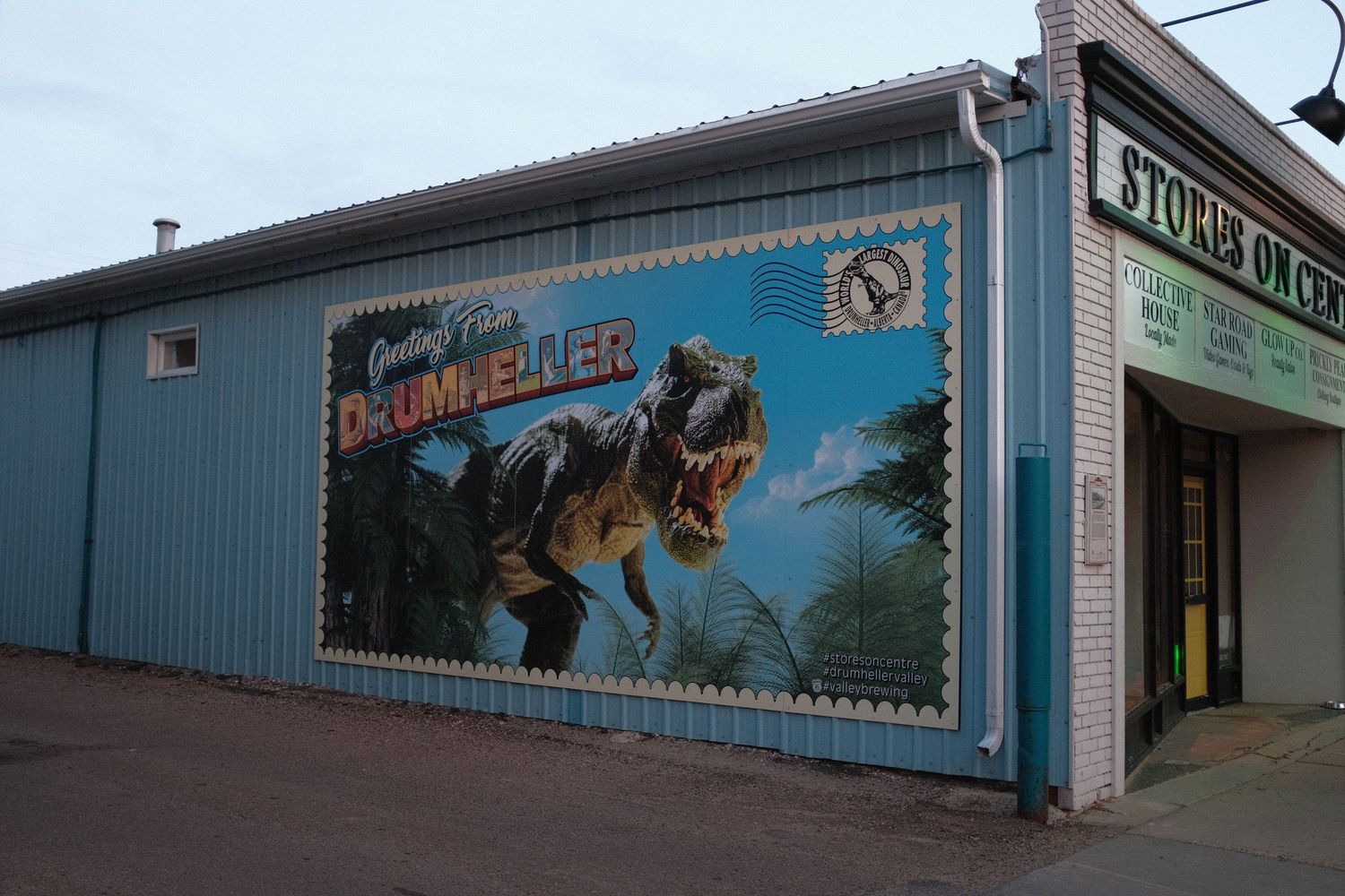 Drumheller Alberta mural featuring a T-Rex dinosaur painted on a building exterior, greeting visitors to the city.