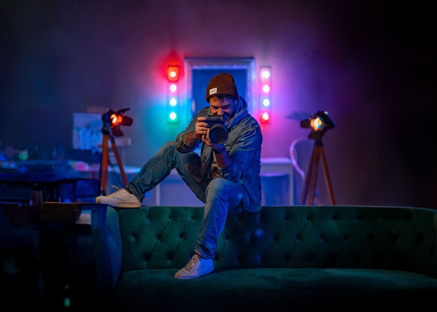 Colorful stage lighting illuminates a dark performance space with blue and red hues.
