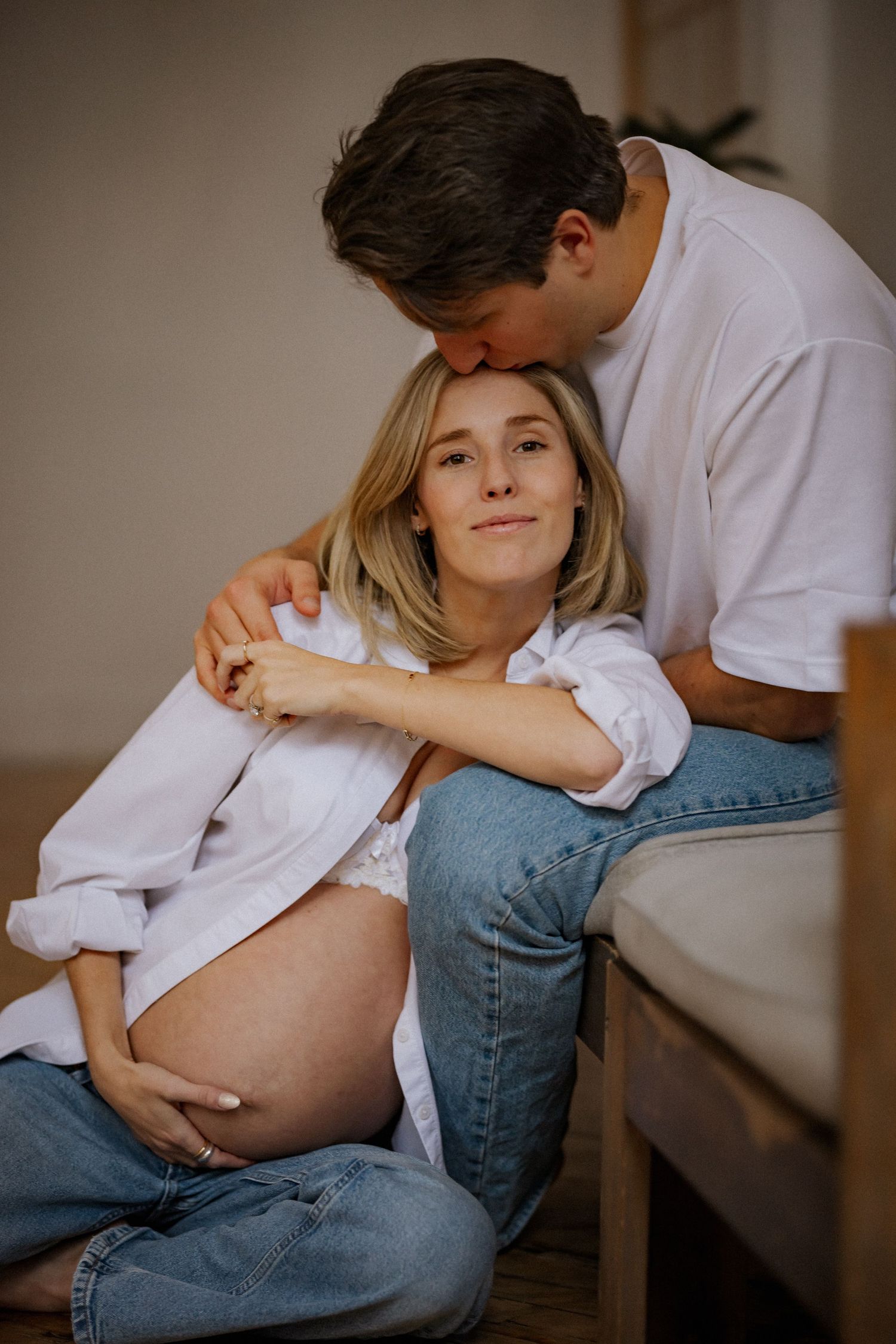 Artistic maternity photos showing loving moments between a couple.