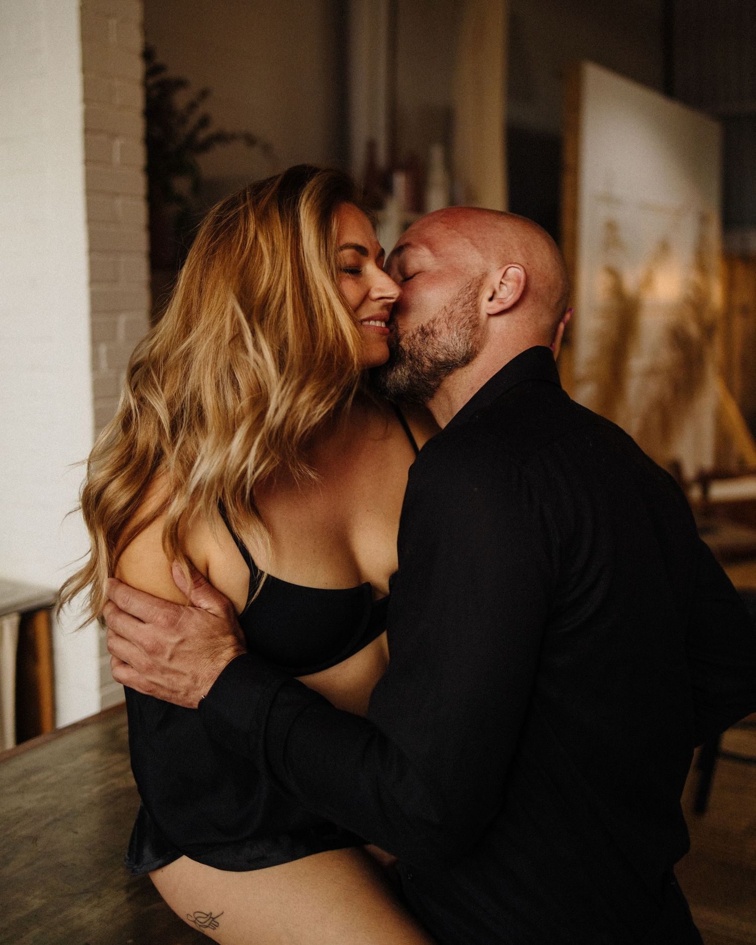 Romantic close-up shots in dim lighting showing tender moments.