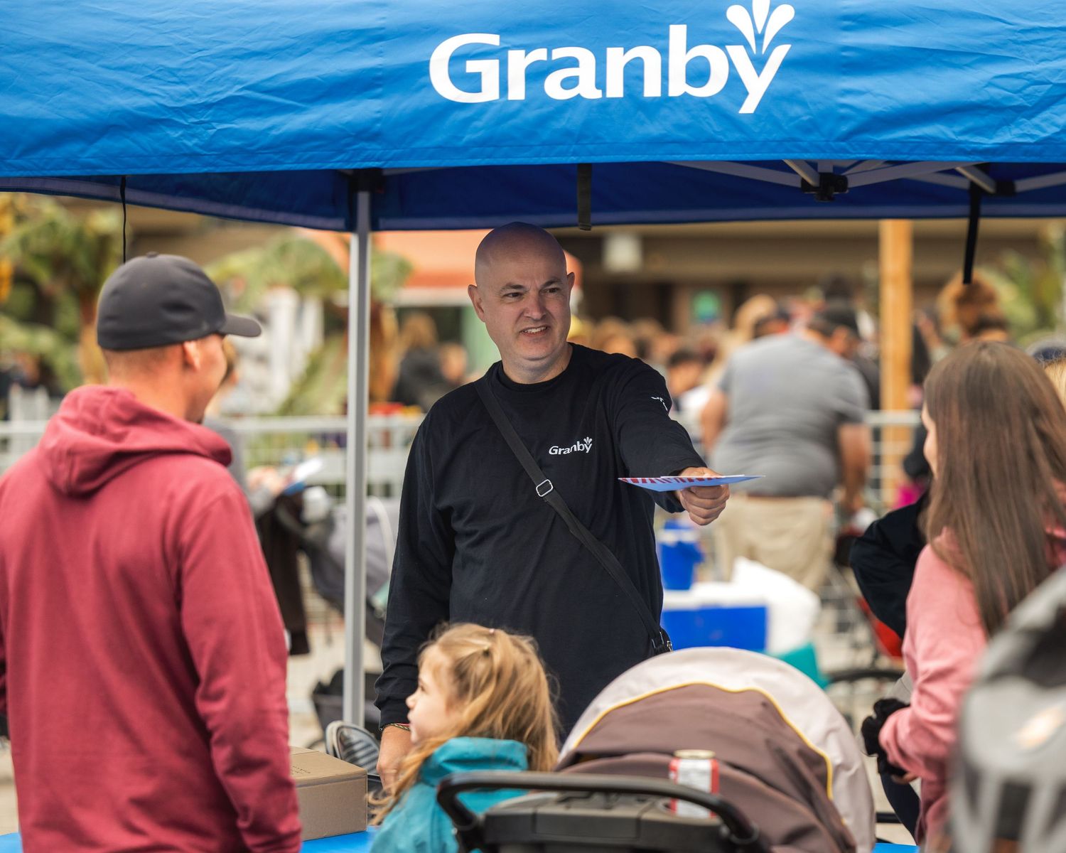 Community members enjoying outdoor winter activities and refreshments at a local event.