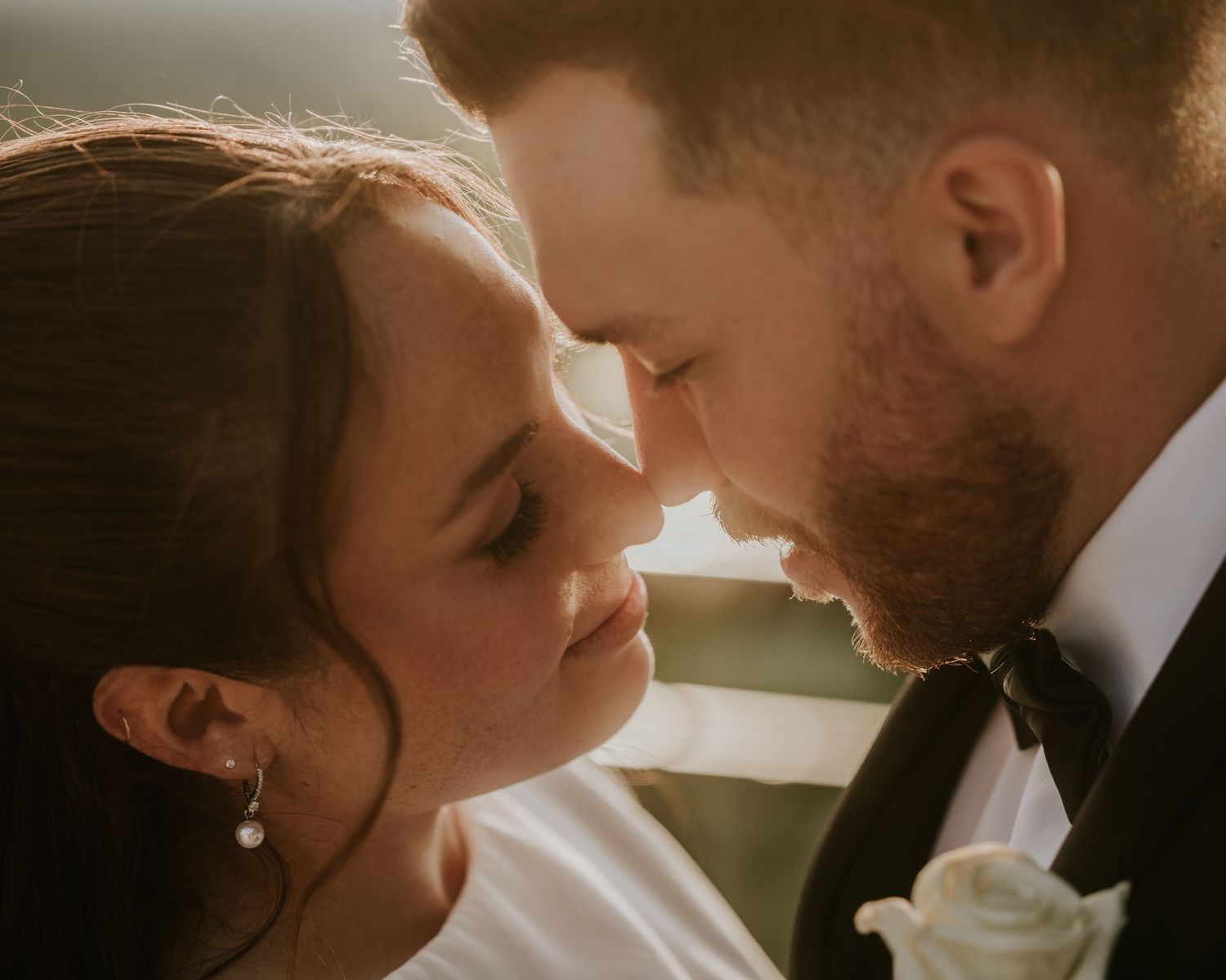 A romantic black and white wedding photo series showing intimate moments between a couple during their special day.