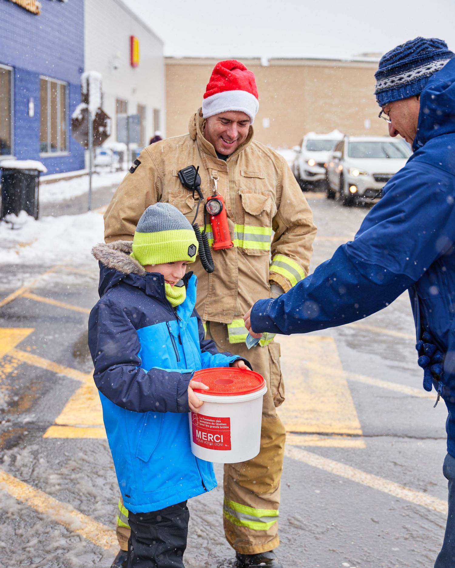 Emergency responders collecting donations in winter weather conditions.