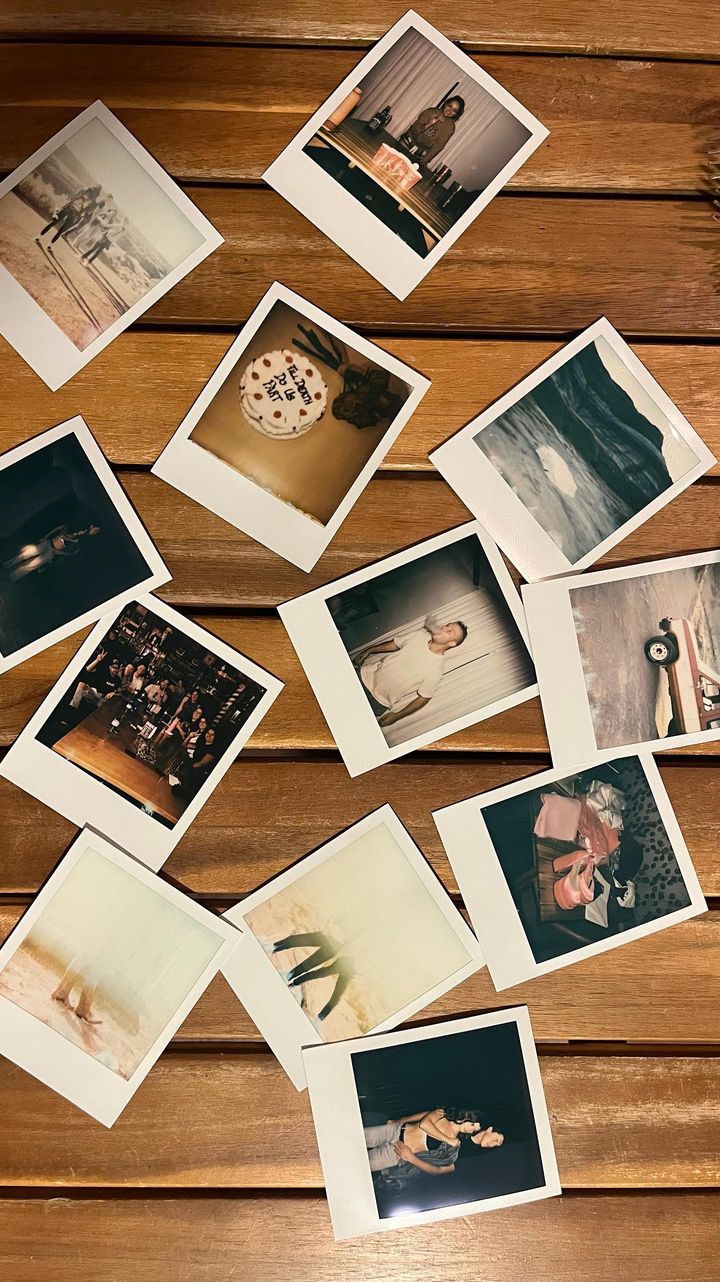 A collection of vintage Polaroid photos scattered on a wooden surface capturing memories of people, places, and celebrations.