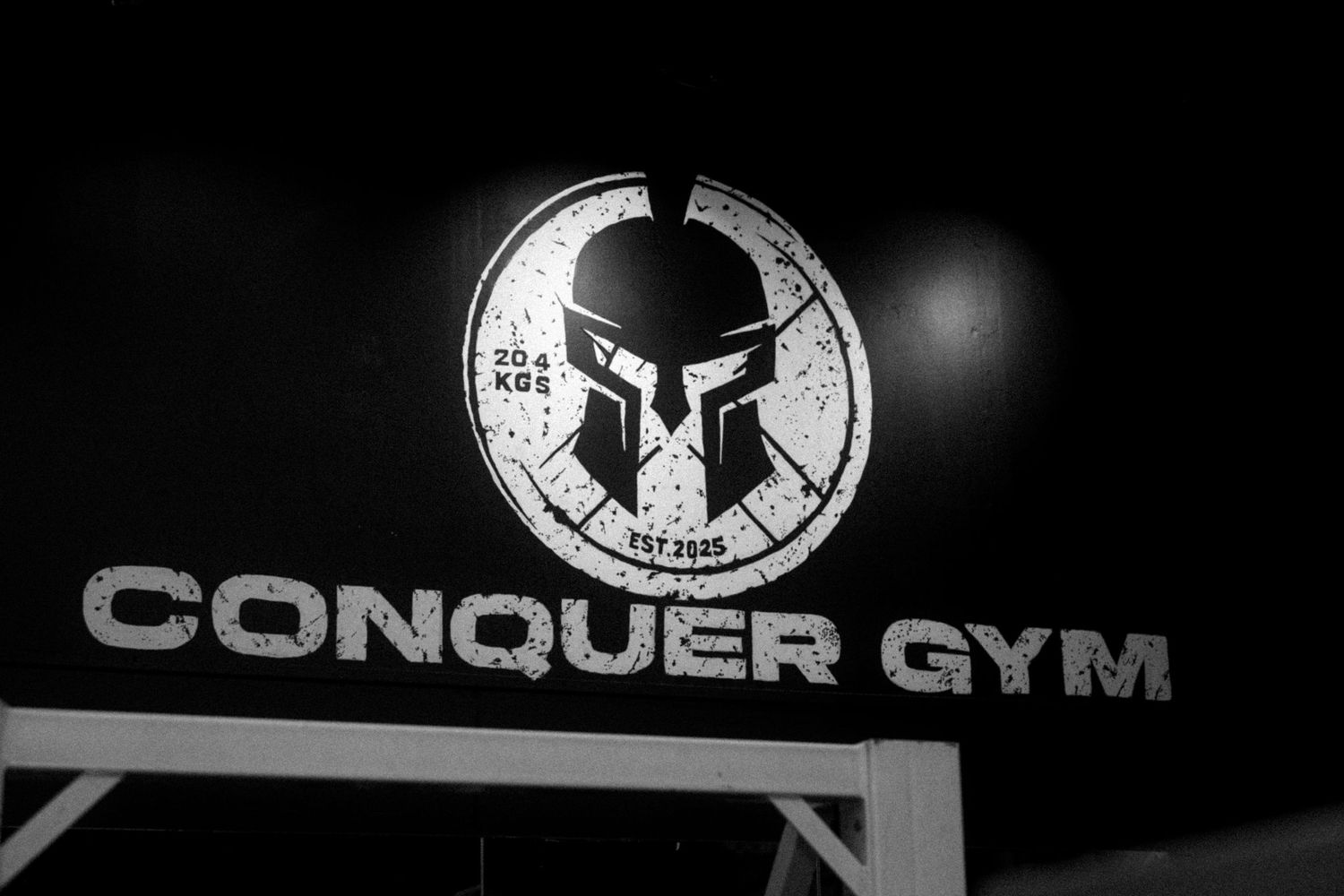 Black and white logo montage showing various fitness and gym related branding elements in a dark theme.