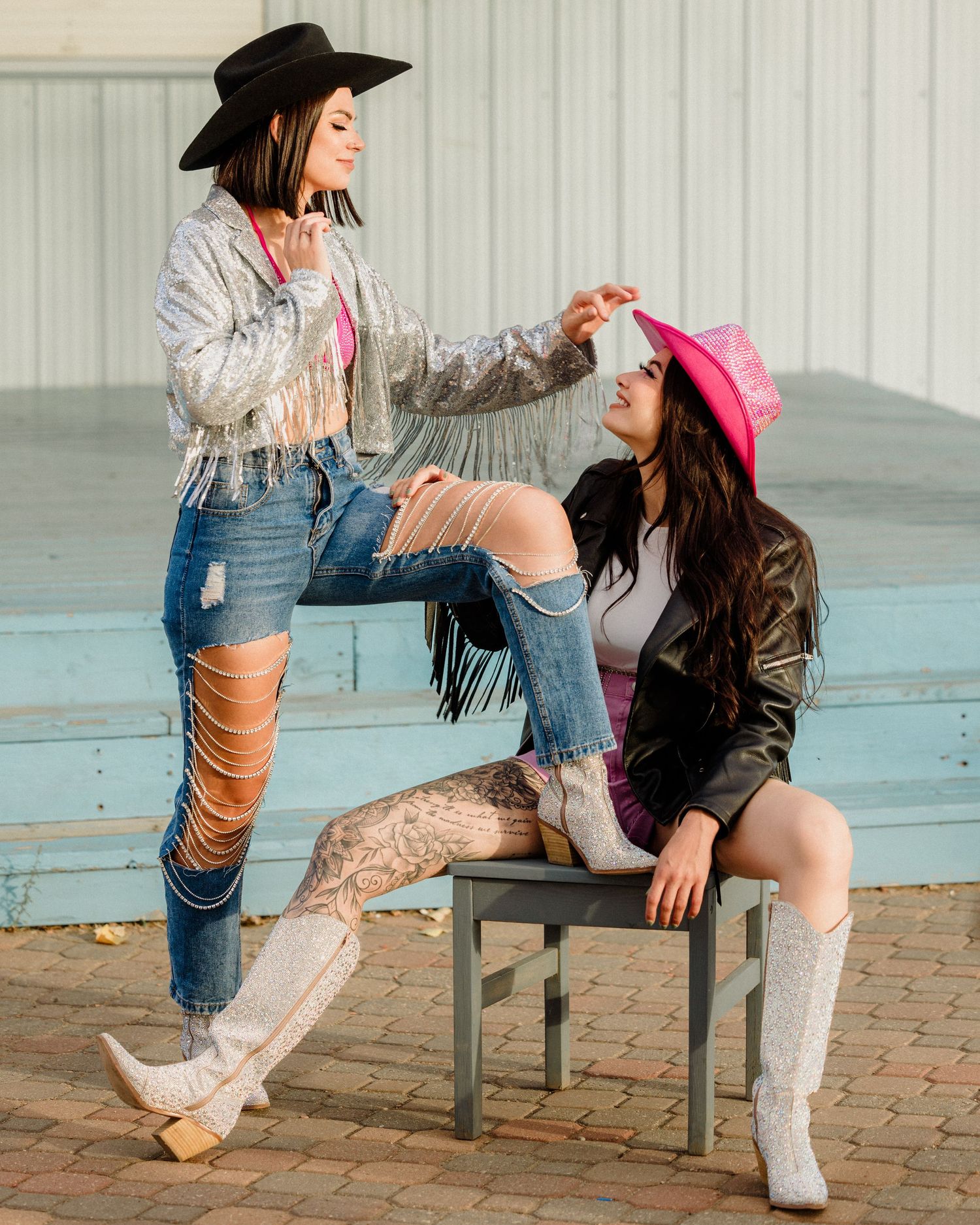 Western-themed photoshoot with cowboy boots and hats on a bench.