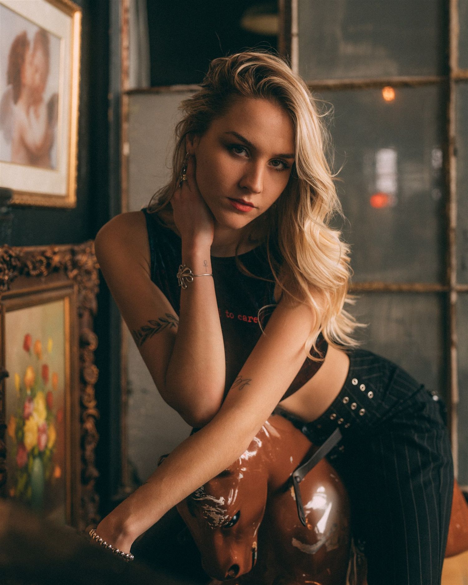 Moody portrait series in vintage setting with dramatic lighting and props.