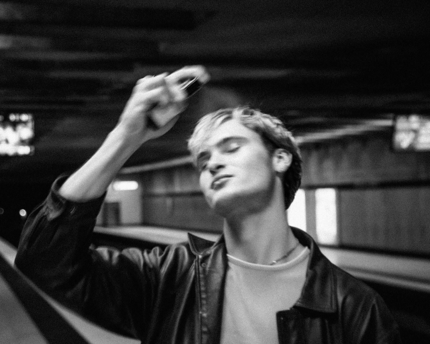 Dramatic black and white portrait series showing artistic poses in low light.