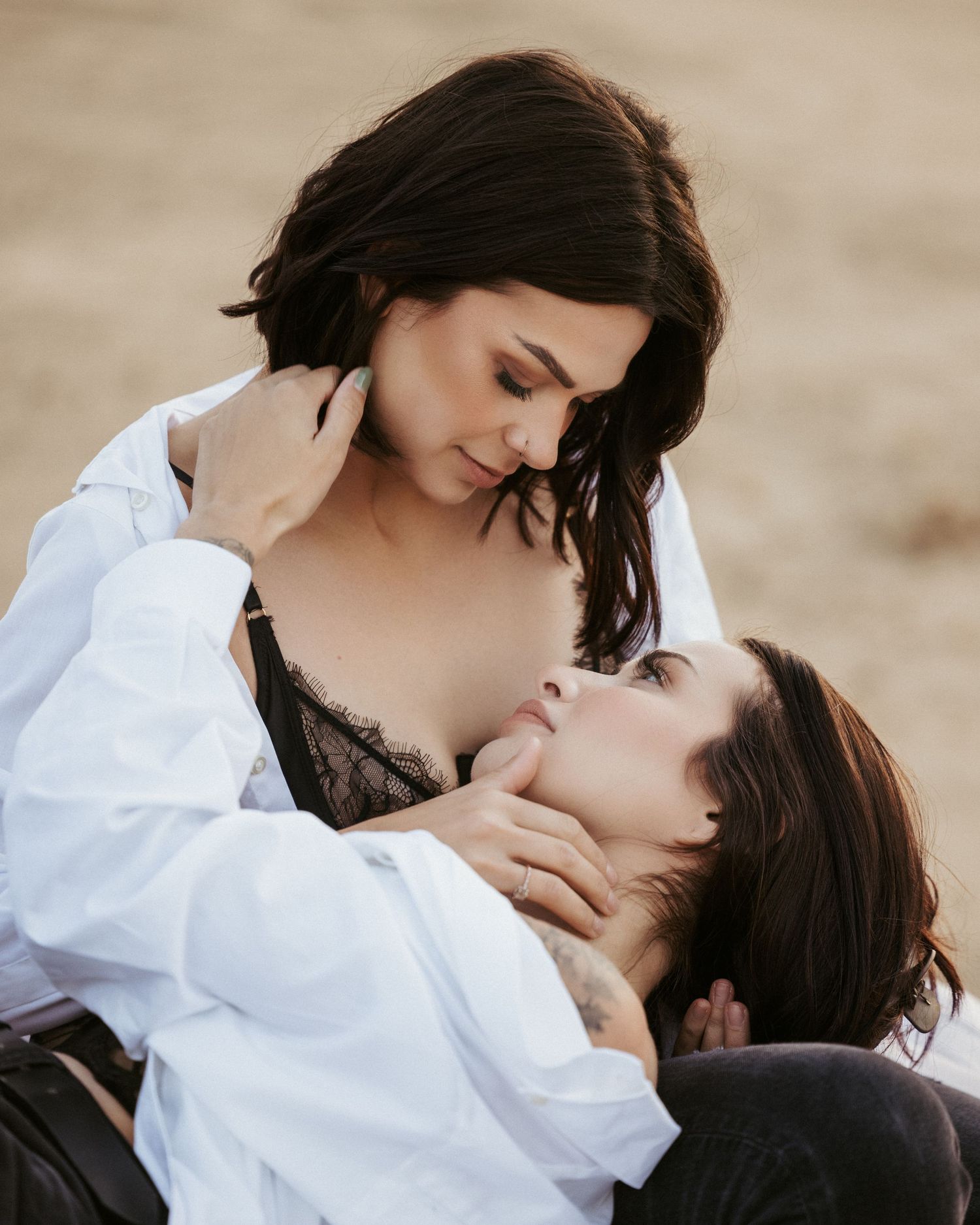 Two people in contrasting black and white clothing share a tender moment.