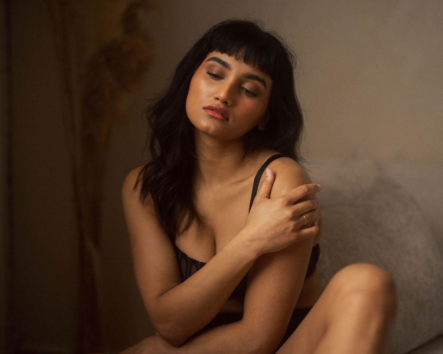 Intimate portrait of a figure in warm lighting creating soft shadows and curves.