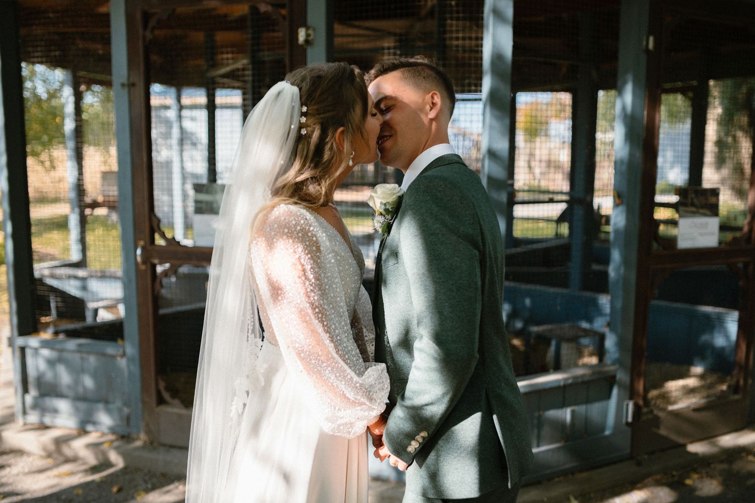 Wedding ceremony in a rustic indoor venue with natural light streaming through windows.