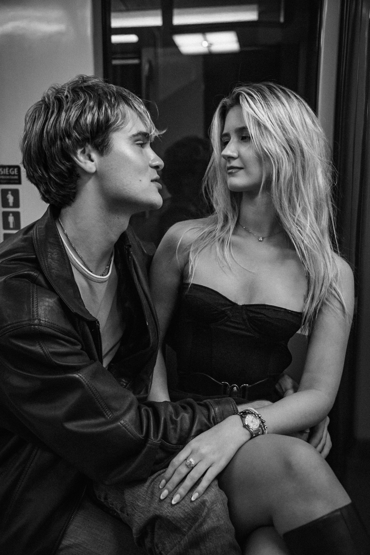 Stylish couple in intimate black and white portrait.