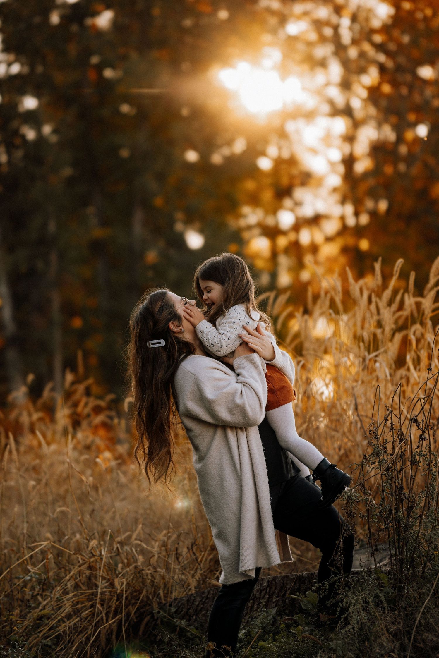 Playful moments captured in a golden field during sunset.