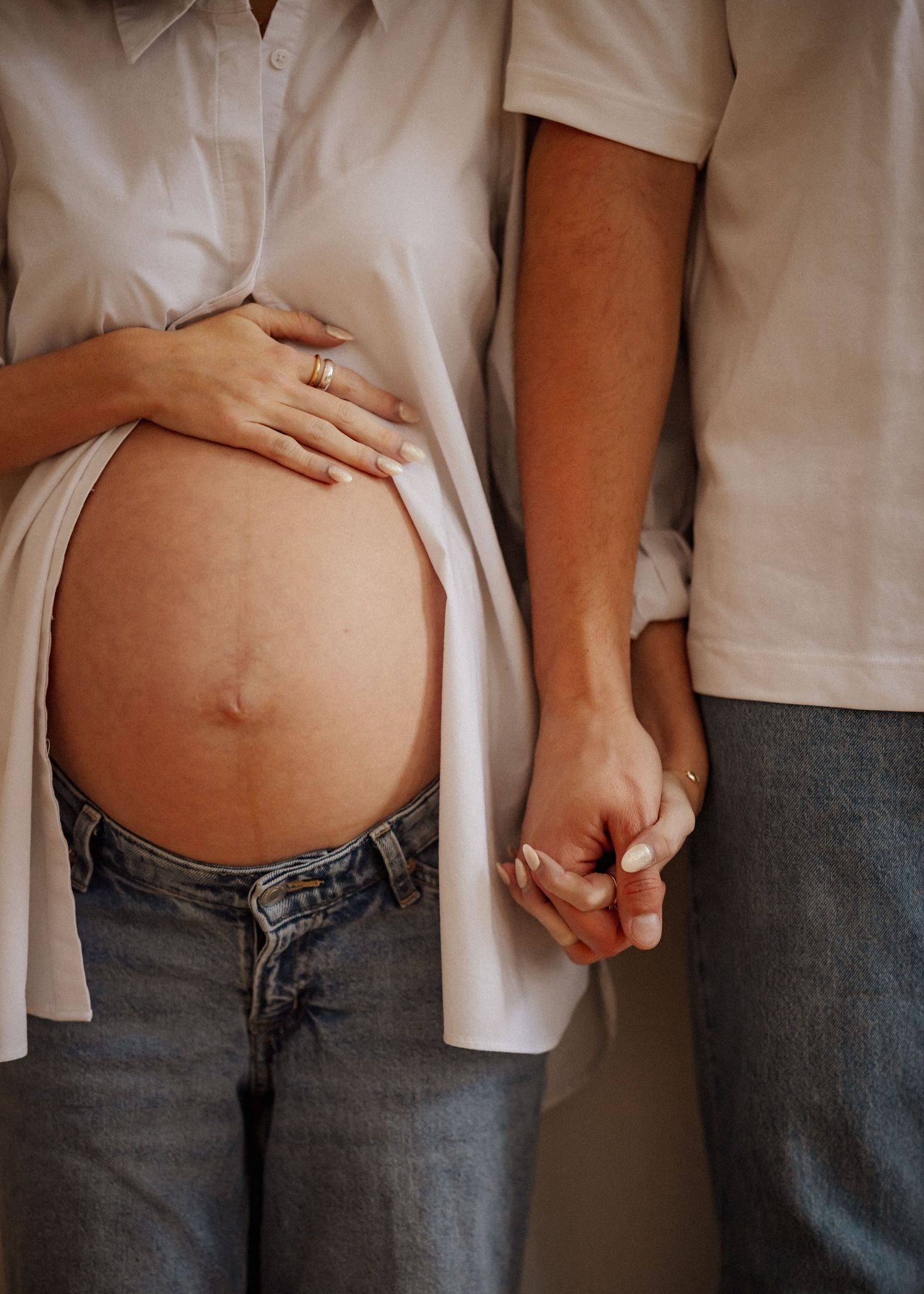 A series of progressive pregnancy belly photos showing growth over time.