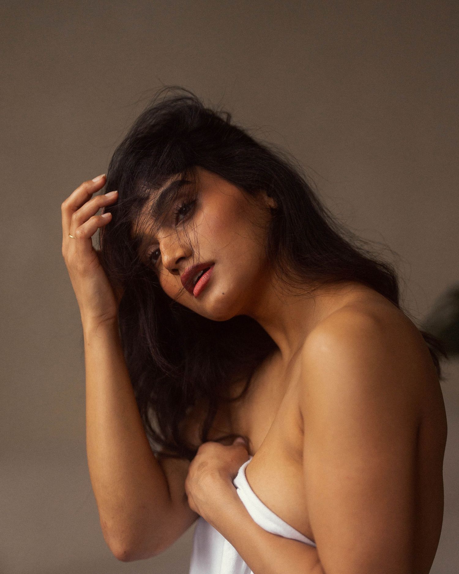 Artistic portrait series in moody lighting showing dramatic poses against dark background.