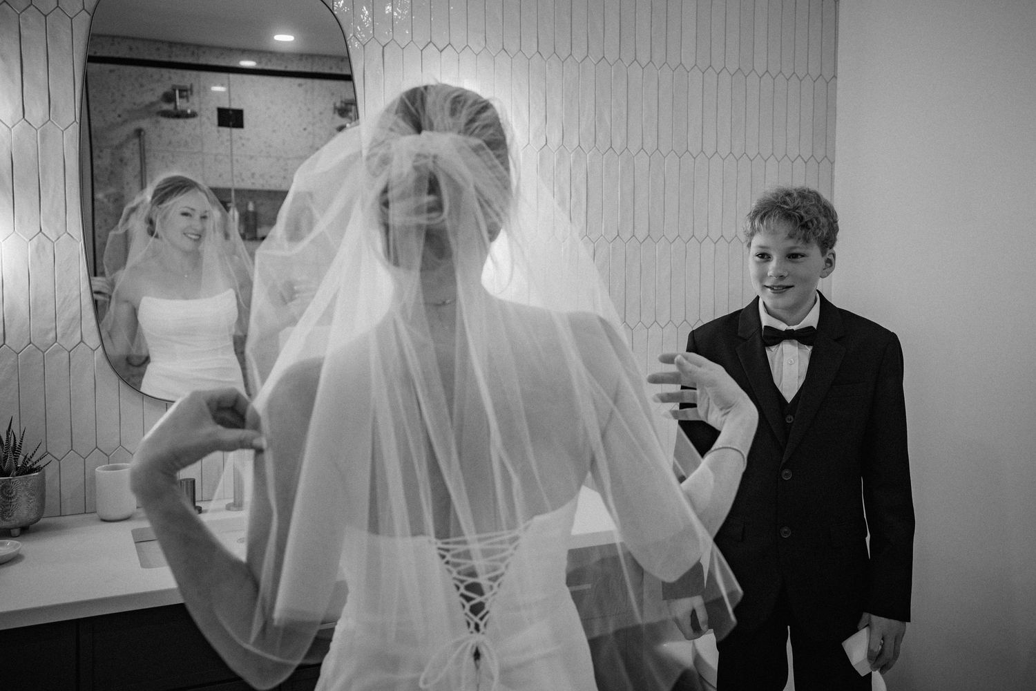 Black and white candid moments during wedding preparations indoors.