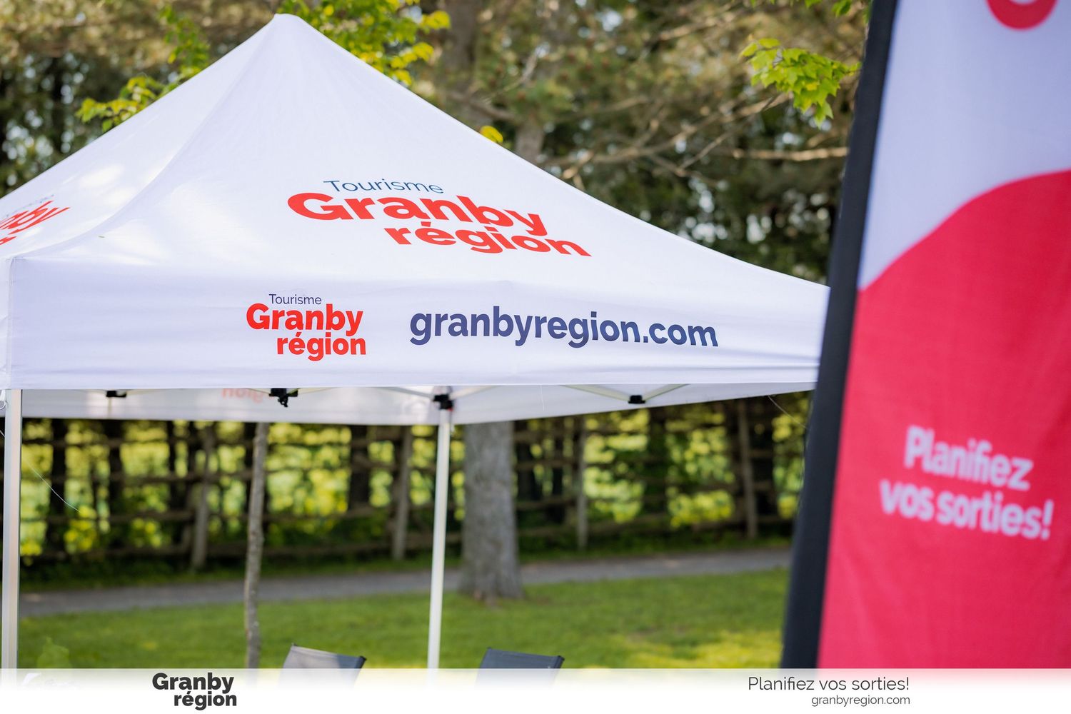 Row of white promotional tents with Granby Region branding outdoors.
