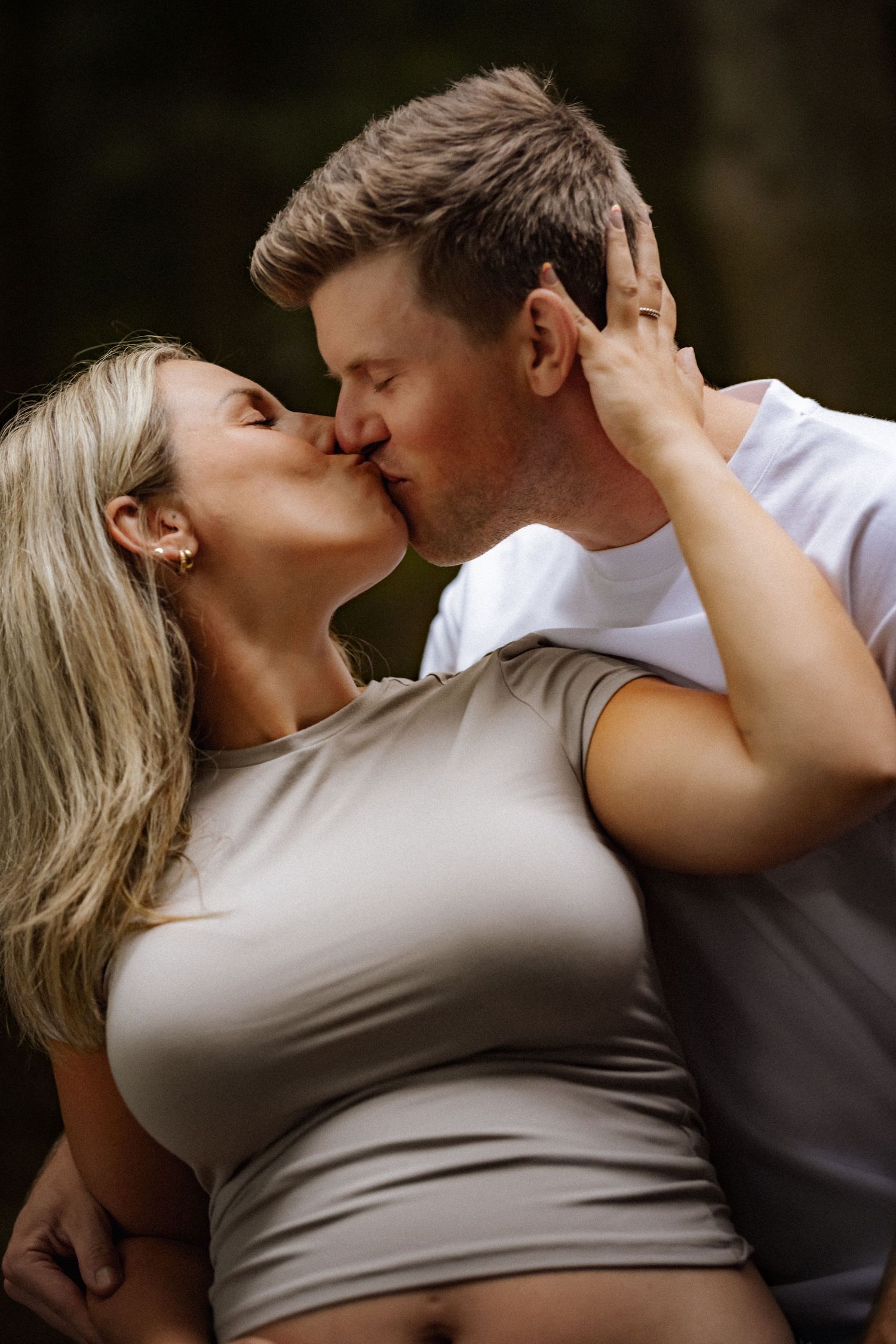Intimate maternity photo series with couple embracing in casual clothing.