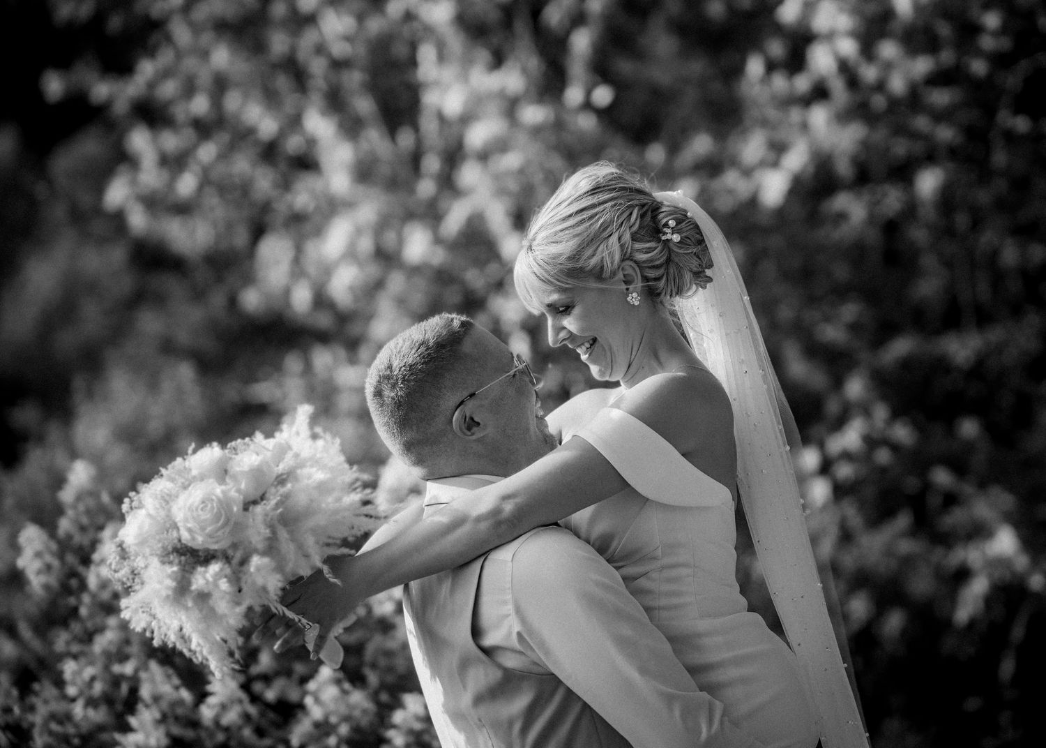Black and white romantic wedding portraits in natural outdoor setting.