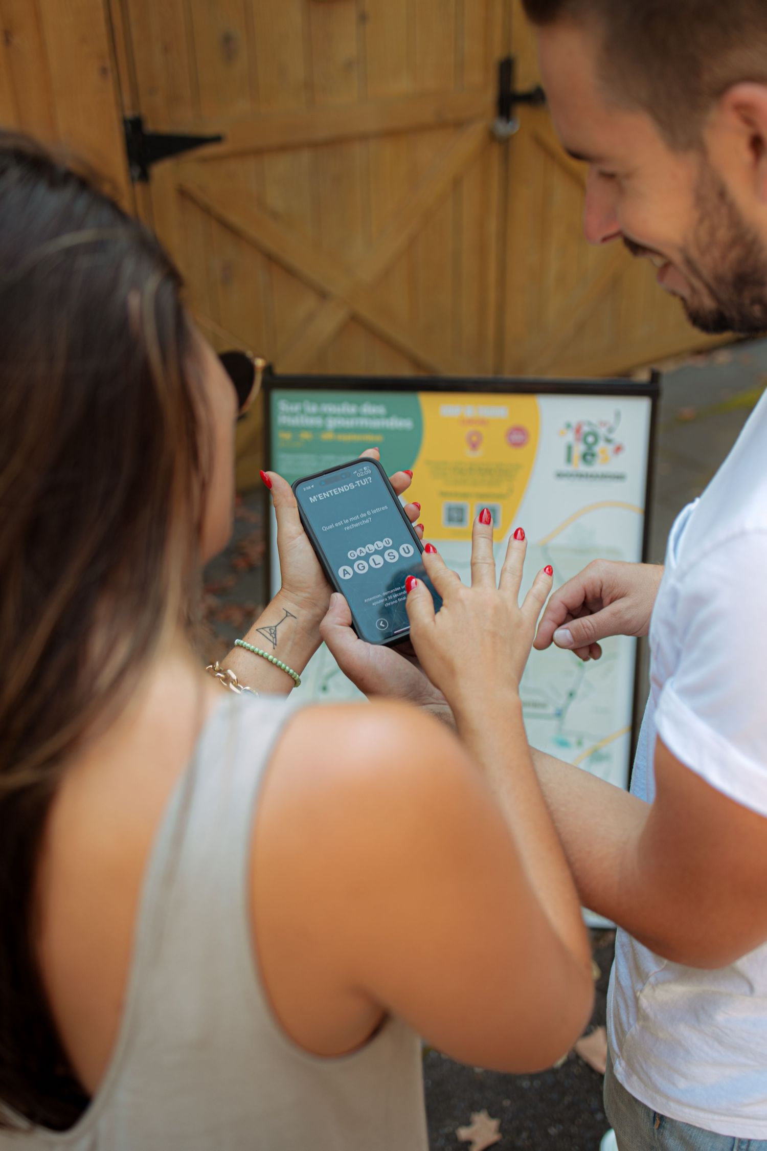 People checking their phones while participating in a guided tasting event.