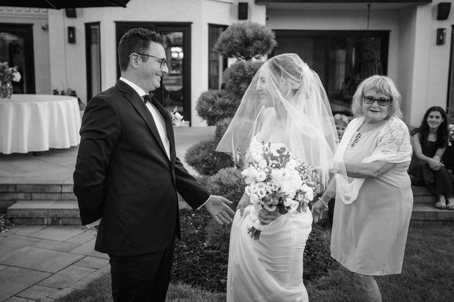Black and white candid moments from outdoor wedding ceremony.