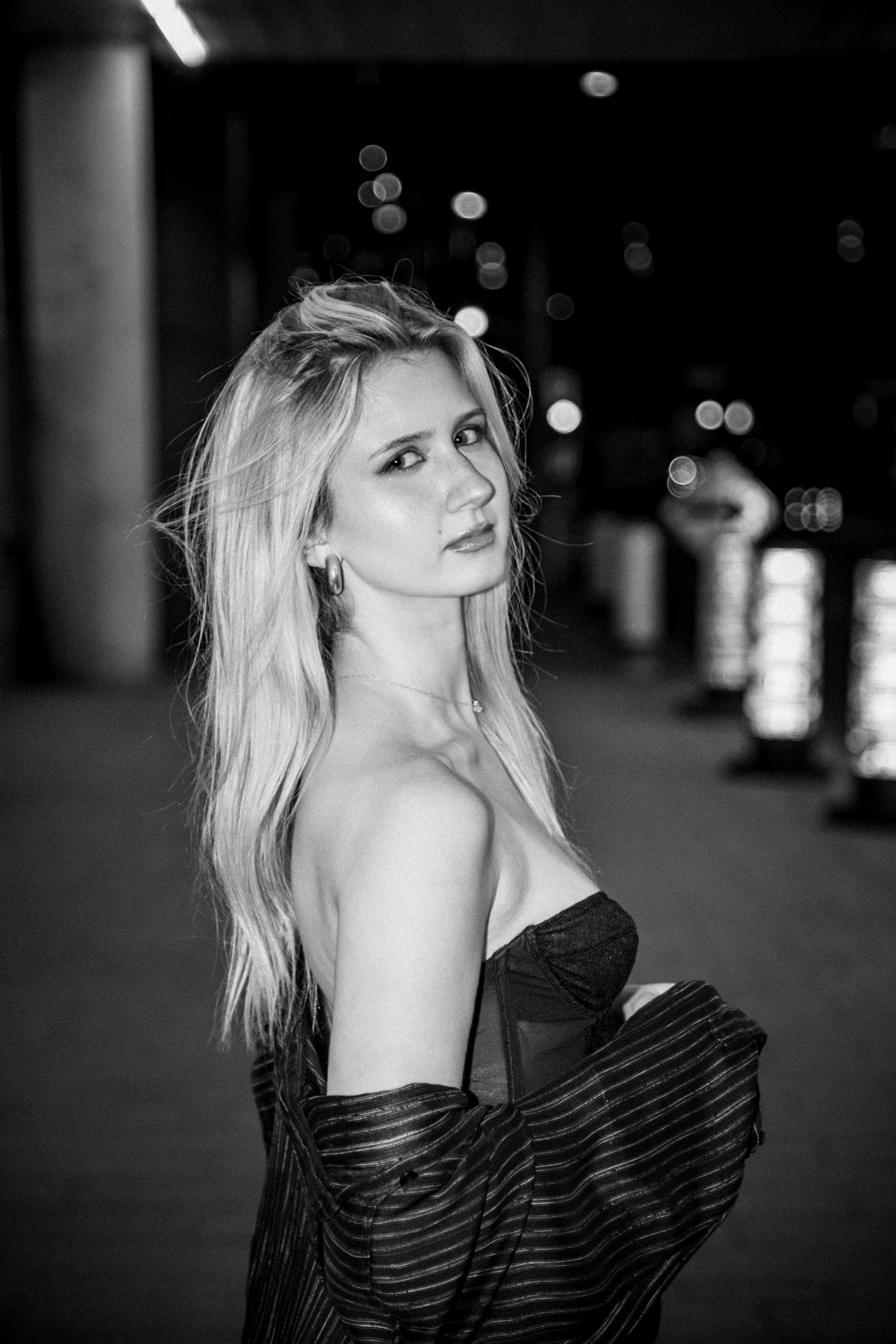 Artistic black and white fashion portraits featuring a striped off-shoulder top.