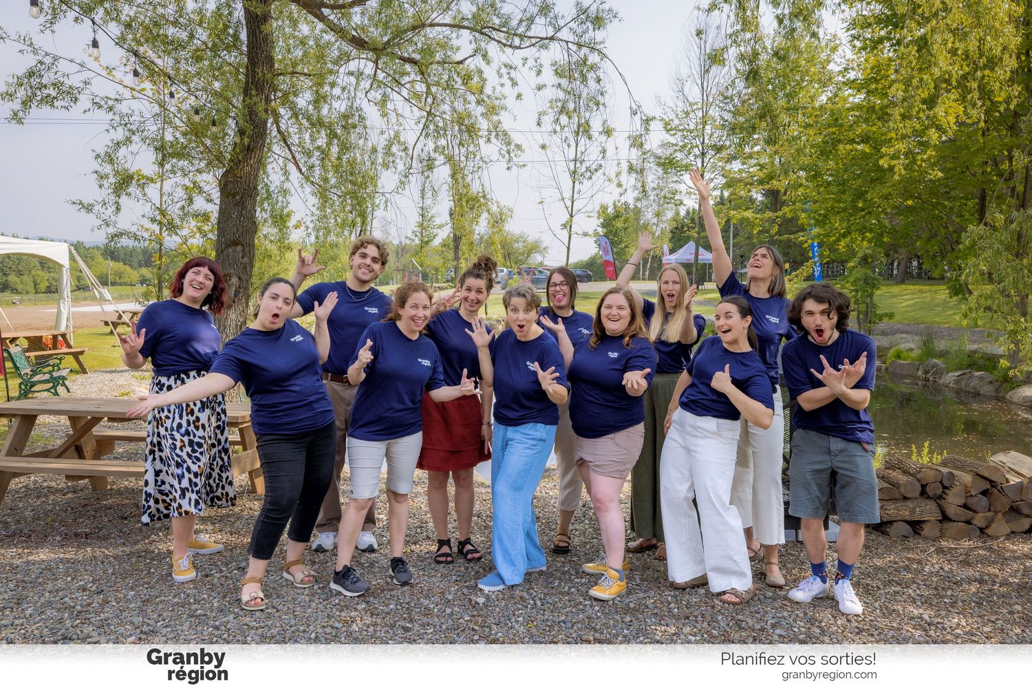 Group of people gathered outdoors wearing blue shirts at a community event.