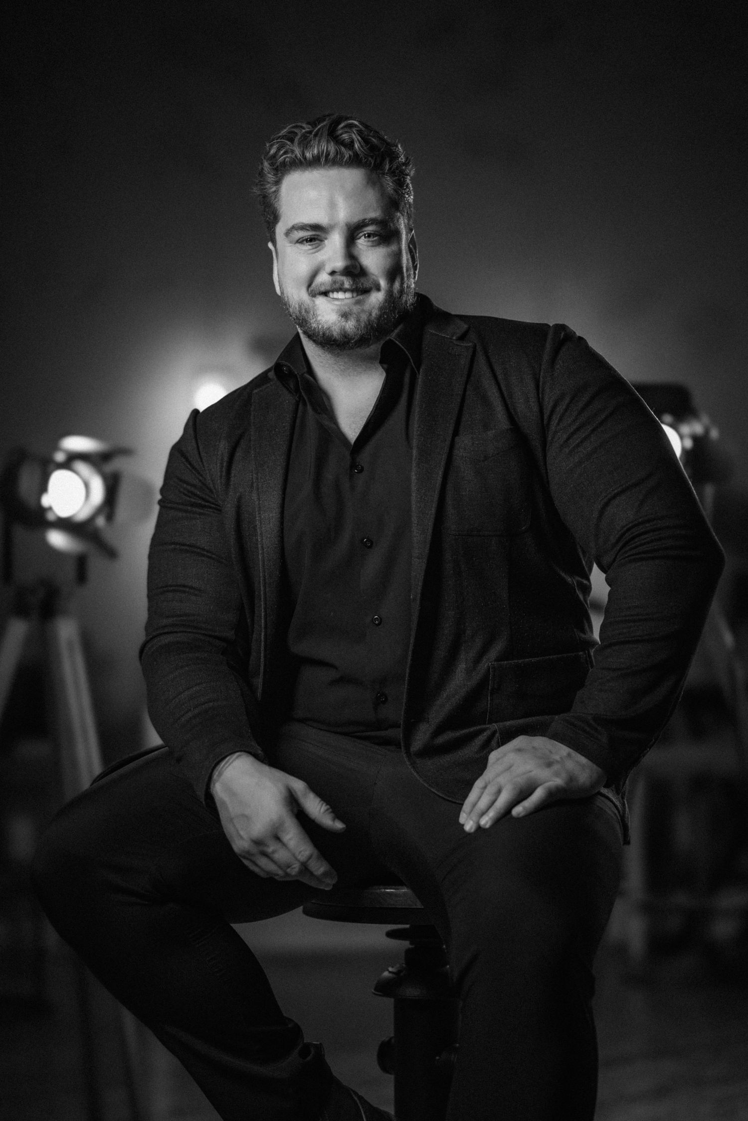 Professional black and white portrait series in dramatic lighting.