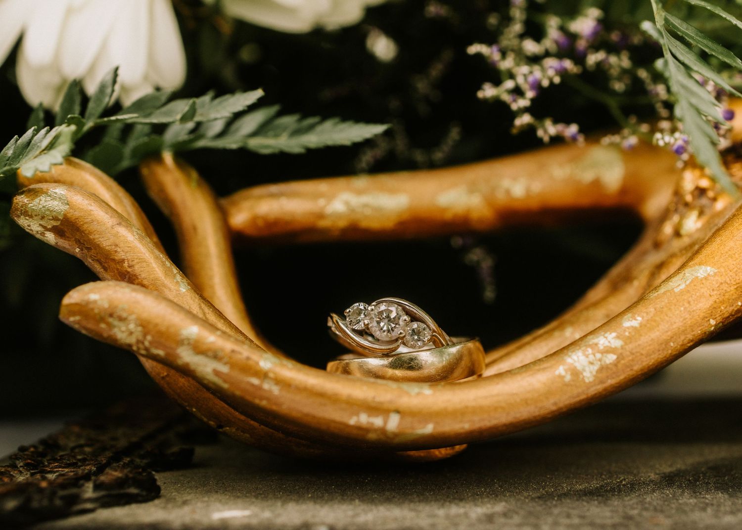 Artistic close-up of curved wooden decor elements with floral arrangements.