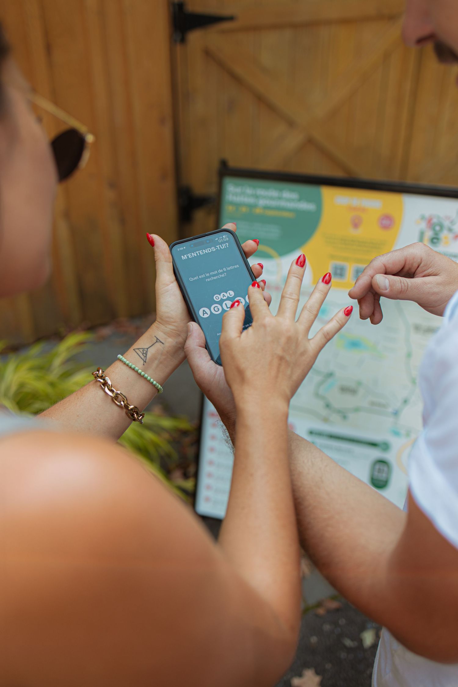 Close-up view of hands holding mobile phones during a guided tasting experience.