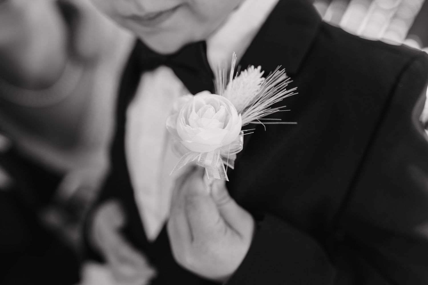 Wedding ceremony detail shot with delicate white feather decorations.