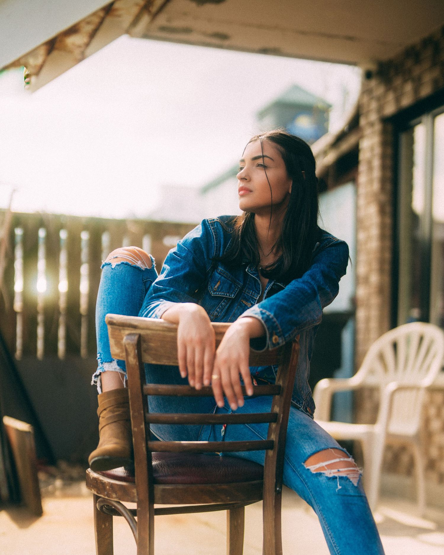 Casual lifestyle portraits on wooden chairs with denim and natural lighting.