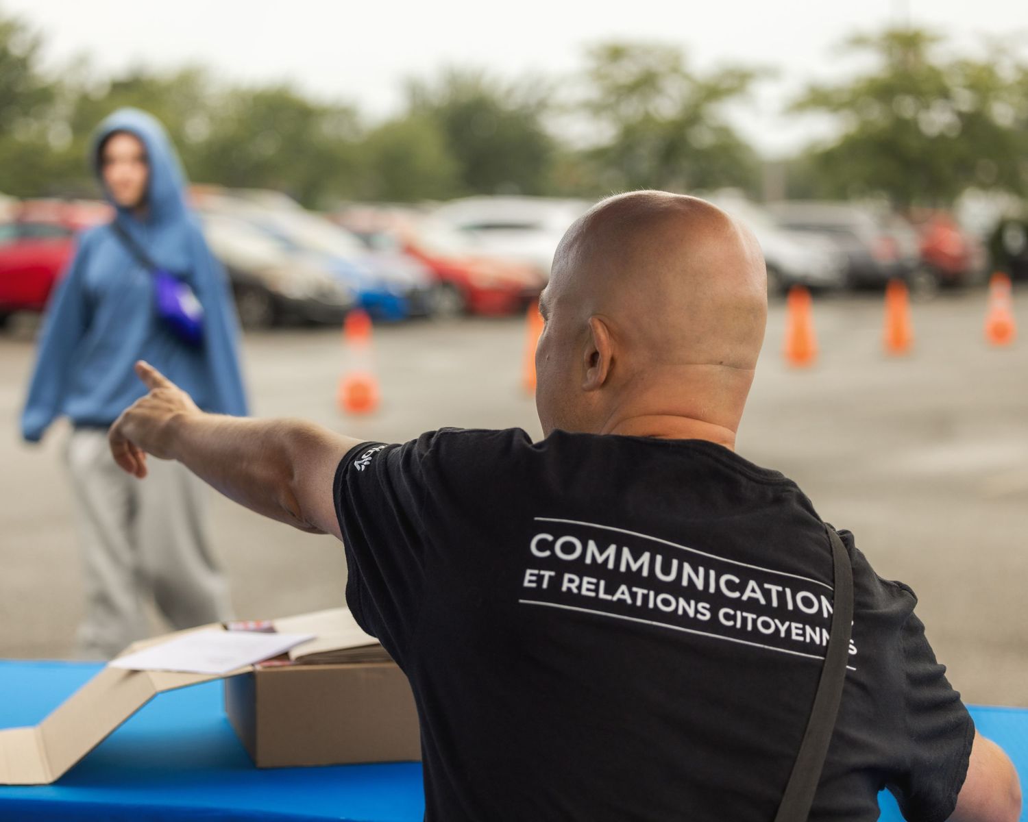 Staff member wearing a black t-shirt with 'Communication' text visible.