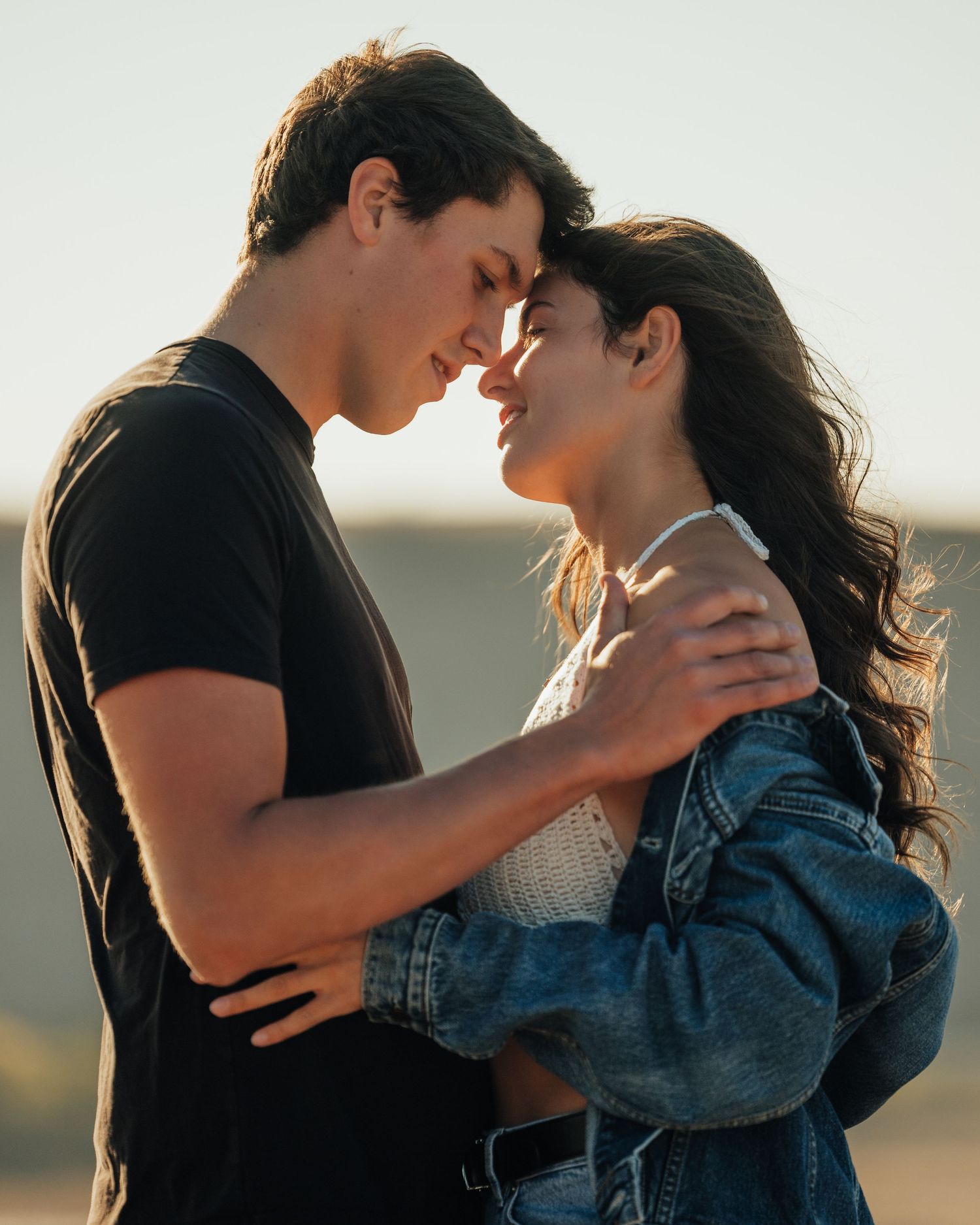 Romantic couple sharing an intimate moment at sunset.