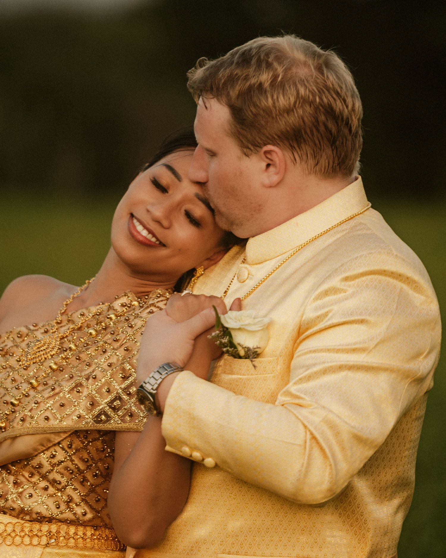 Intimate couple portraits in golden formal wear against dark natural backdrop.
