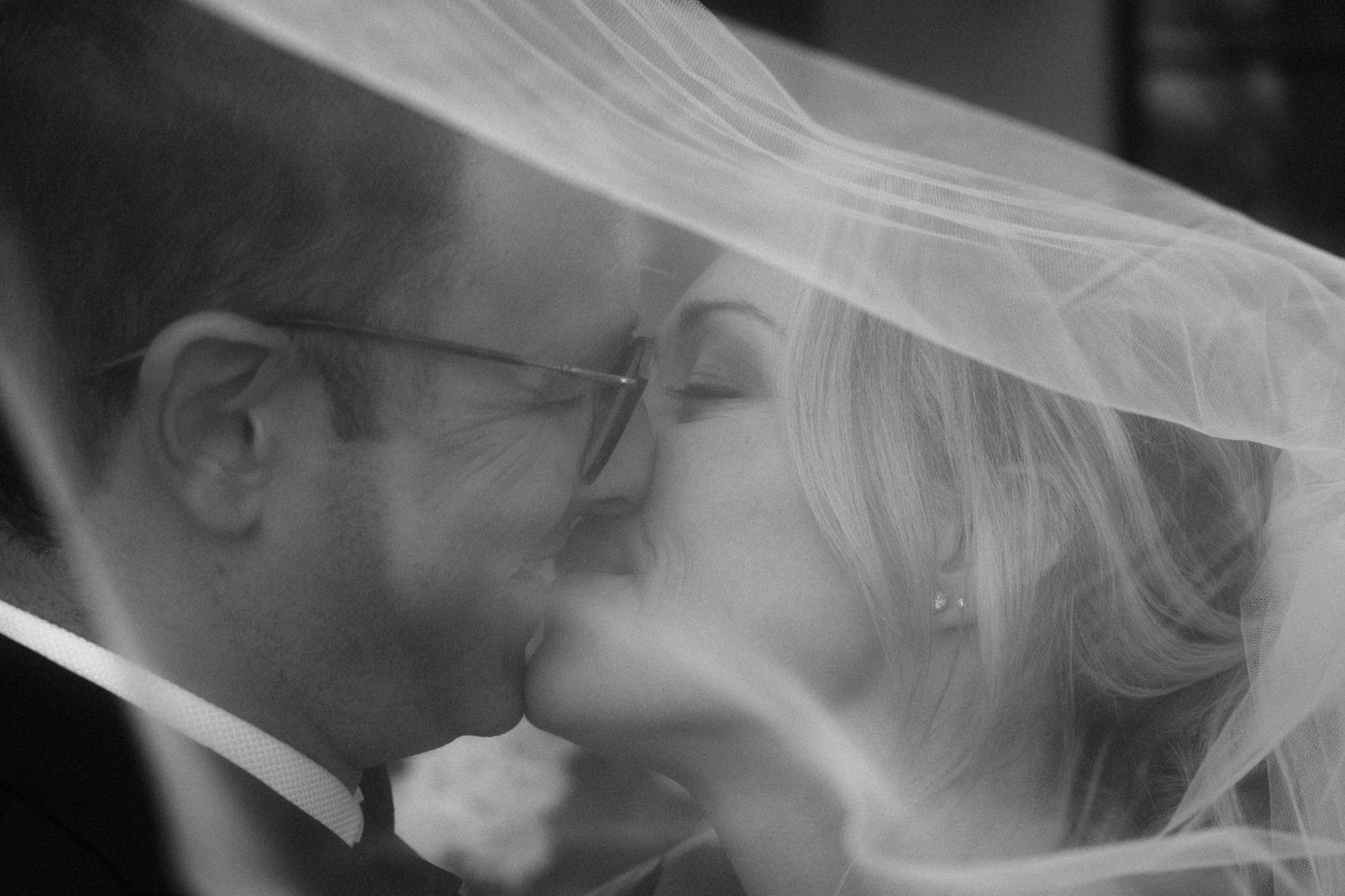 Close-up shots of wedding veil details in black and white.