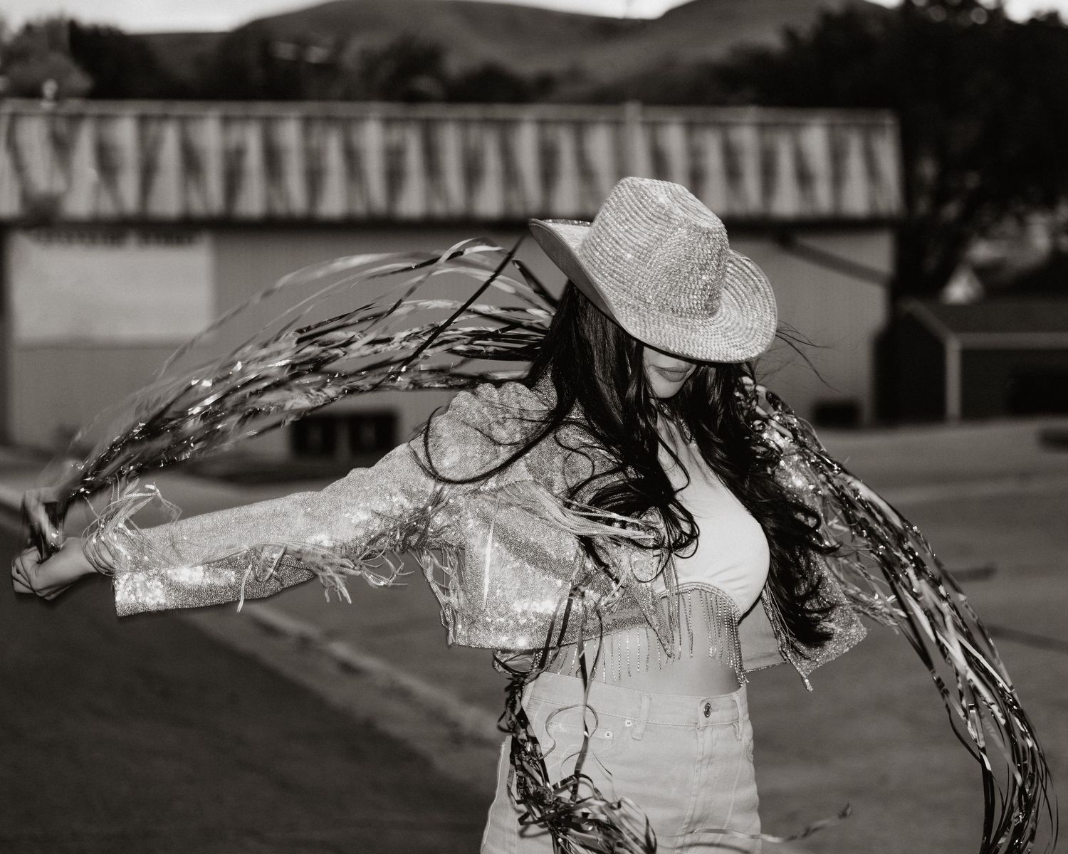 Dynamic black and white motion shot with flowing fabric against an outdoor backdrop.