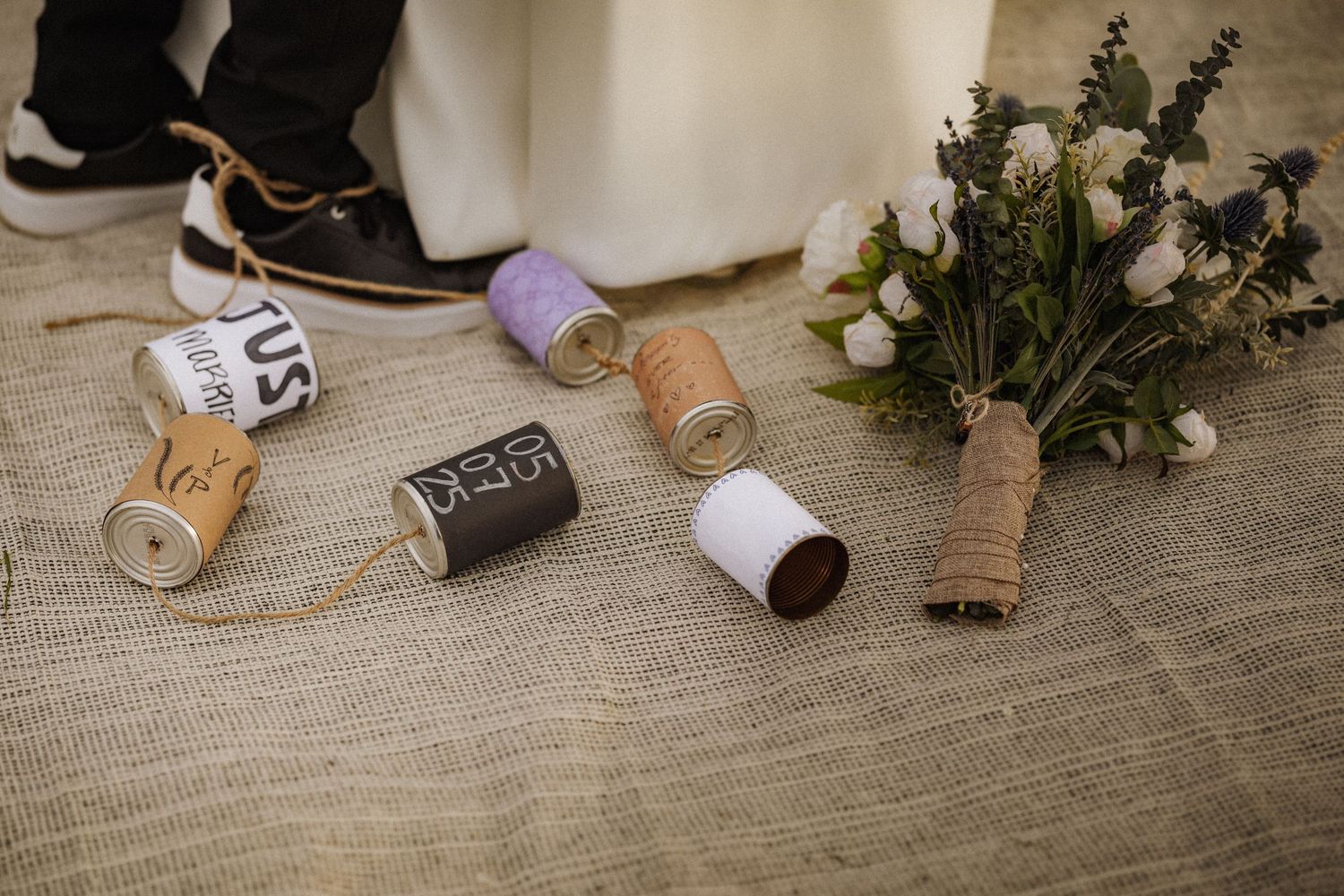 Rustic wedding decor and invitation details displayed on wooden surface.