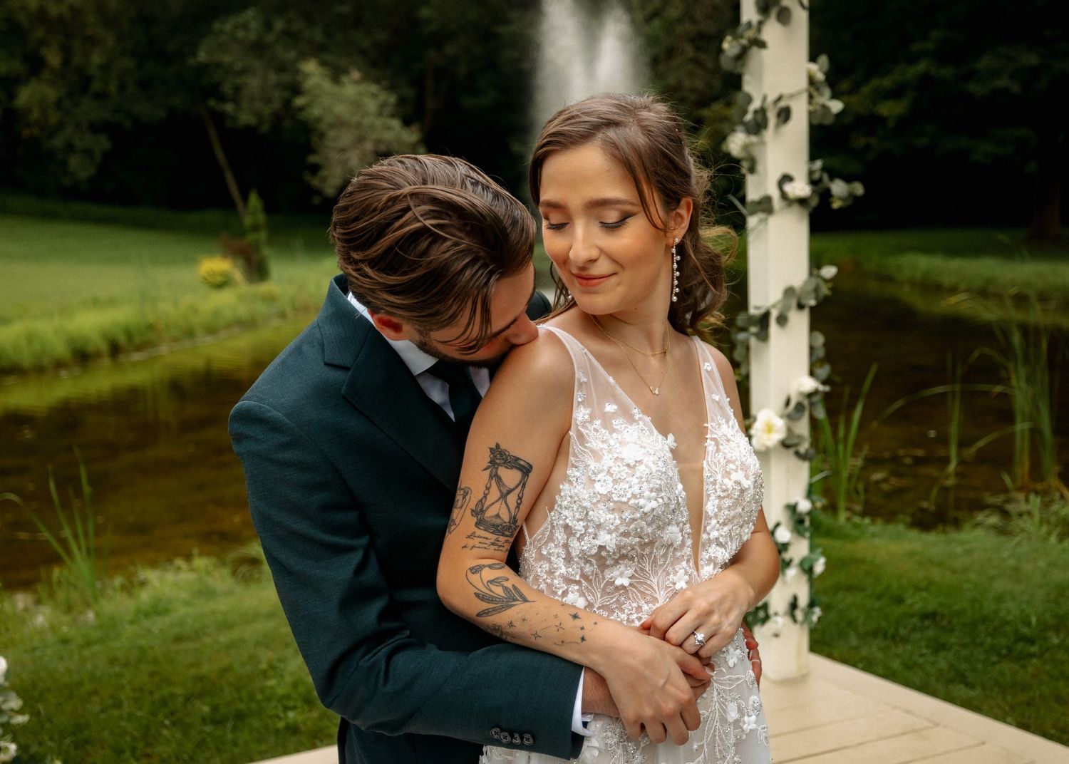 A tender embrace between newlyweds during their outdoor wedding ceremony.