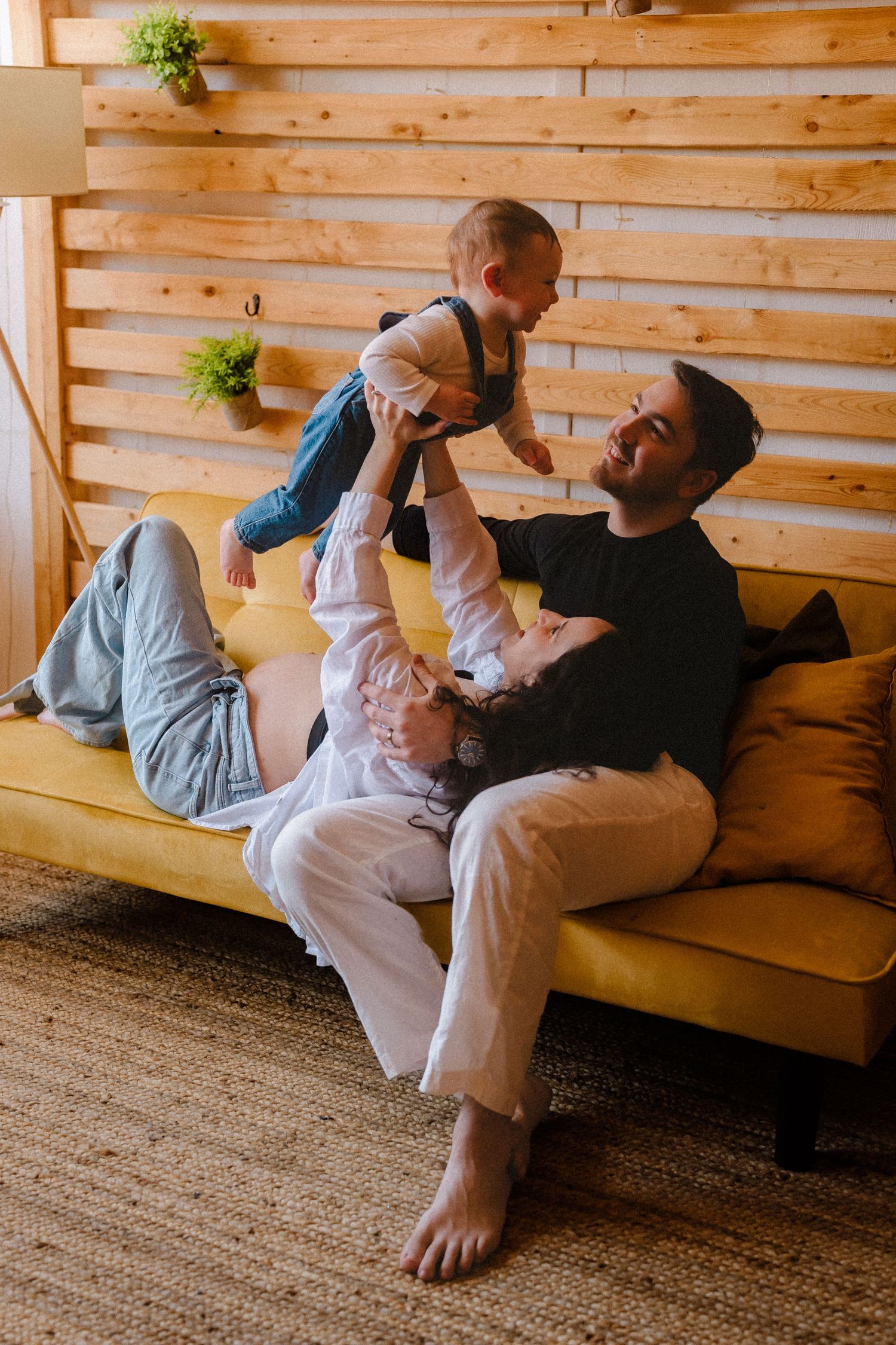 Couple relaxing together on wooden furniture in a rustic cabin setting.
