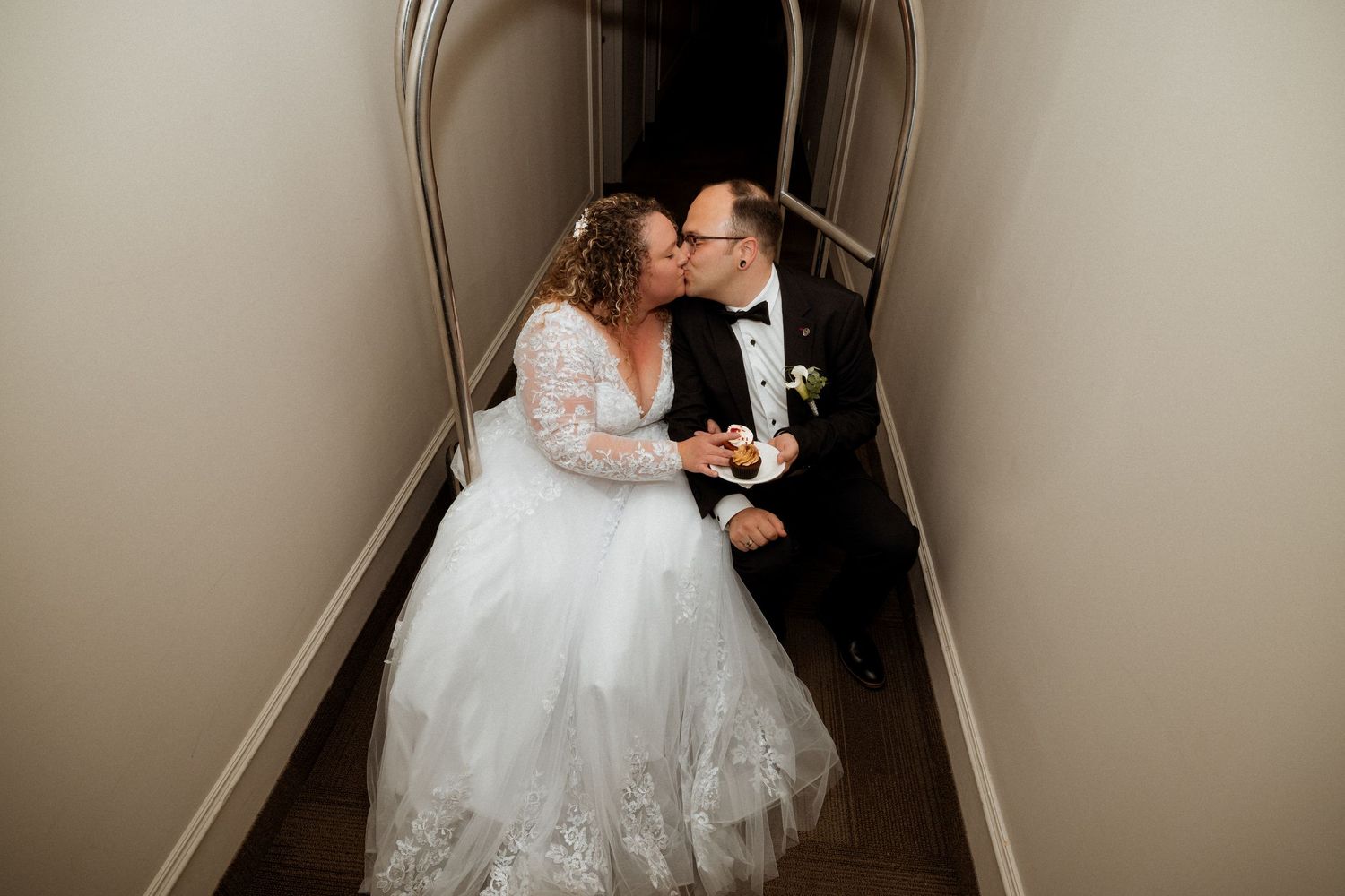 Couple dancing in intimate hallway setting with dramatic lighting.