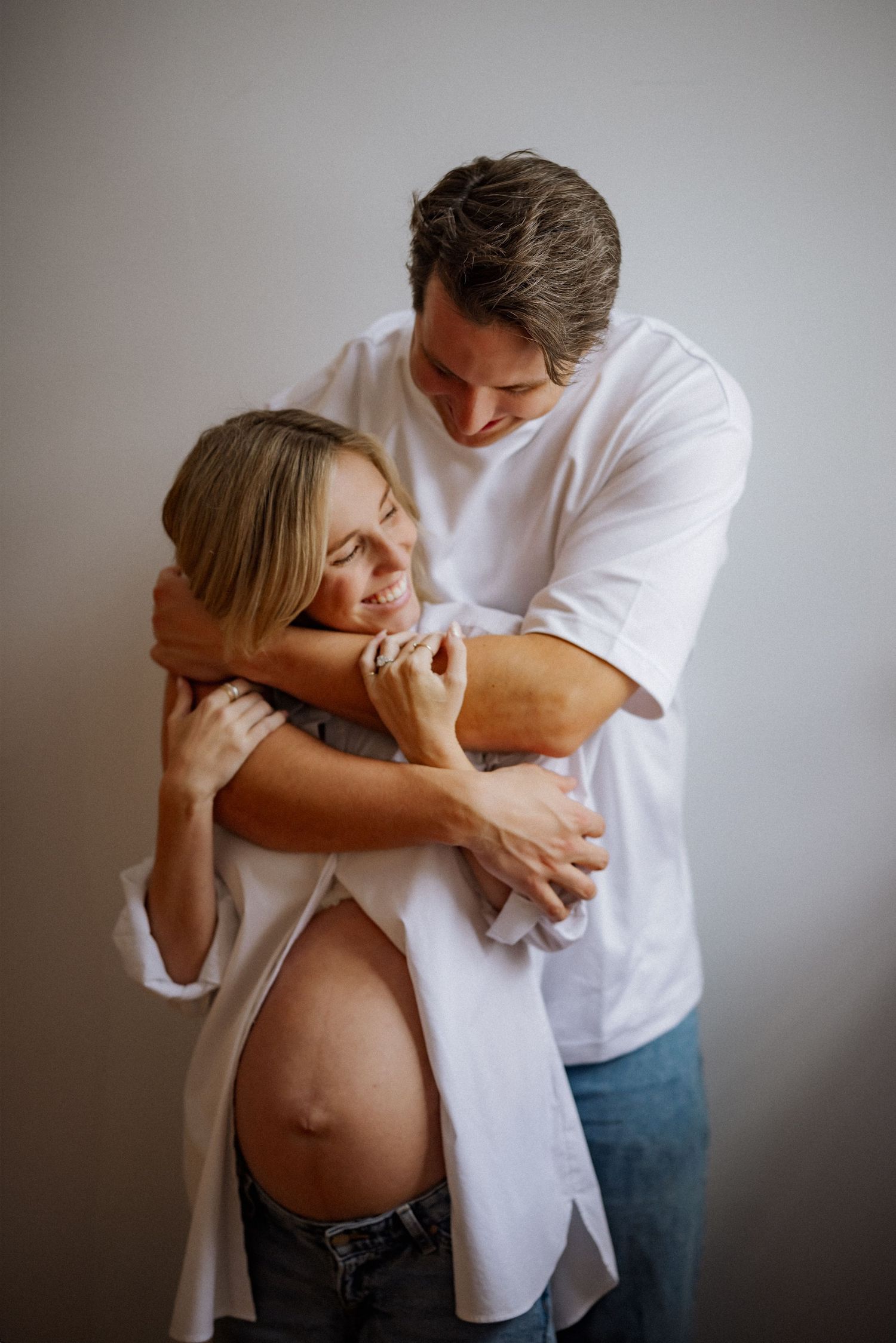 Intimate maternity photos capturing tender moments between expecting parents.