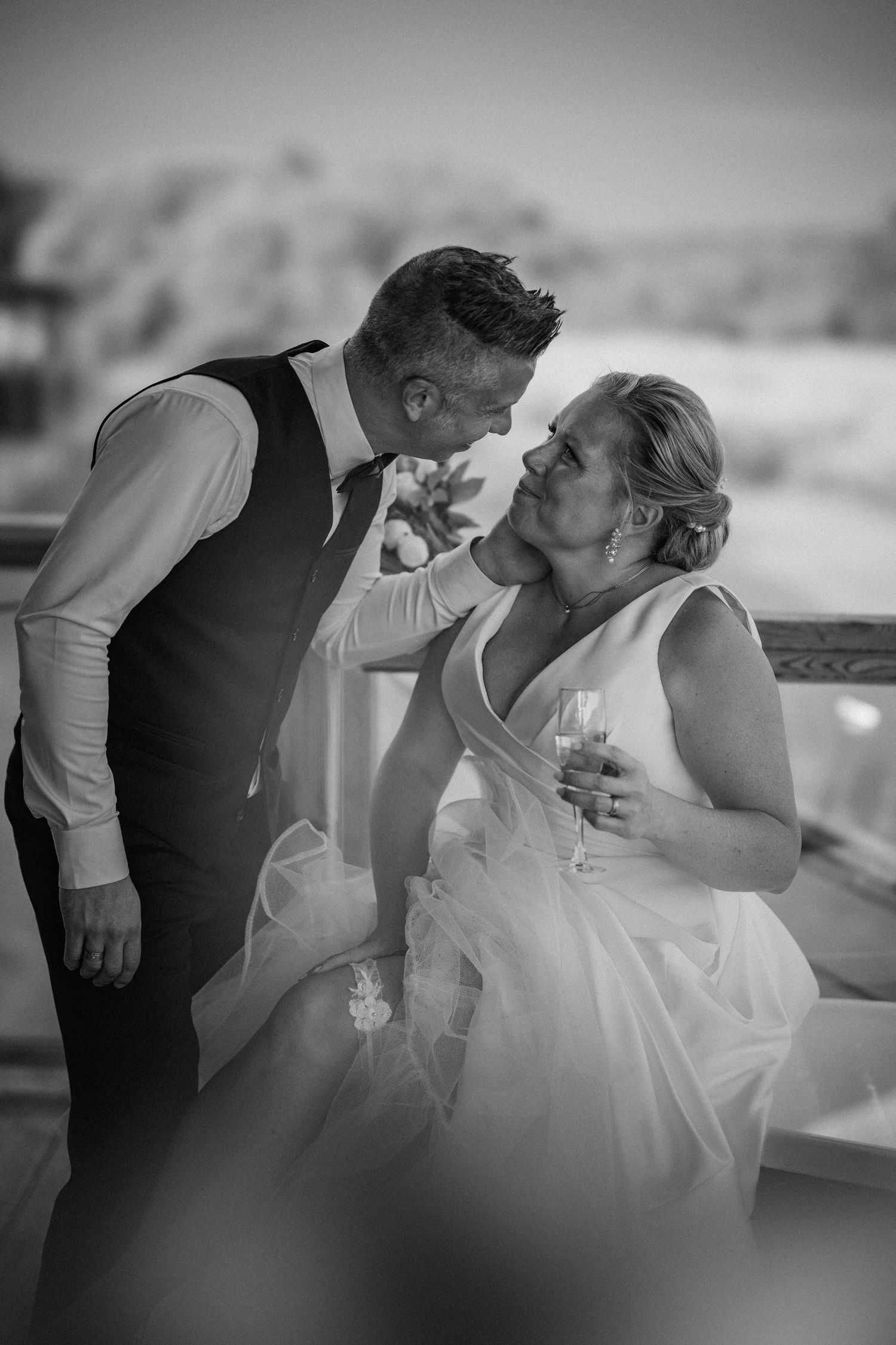 Dramatic black and white sequence of a romantic dip kiss during a wedding dance.