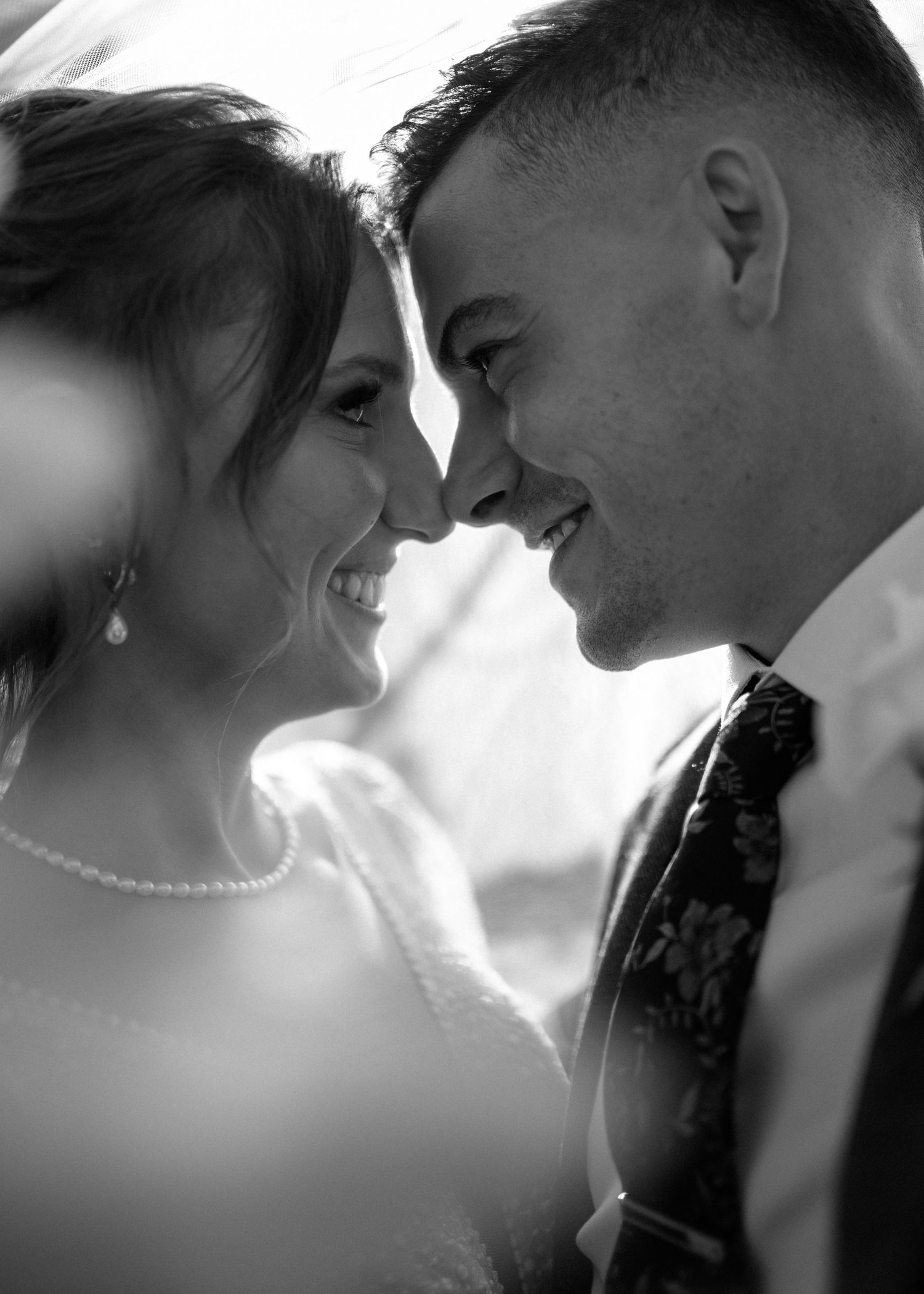 Black and white intimate portrait of couple in silhouette.