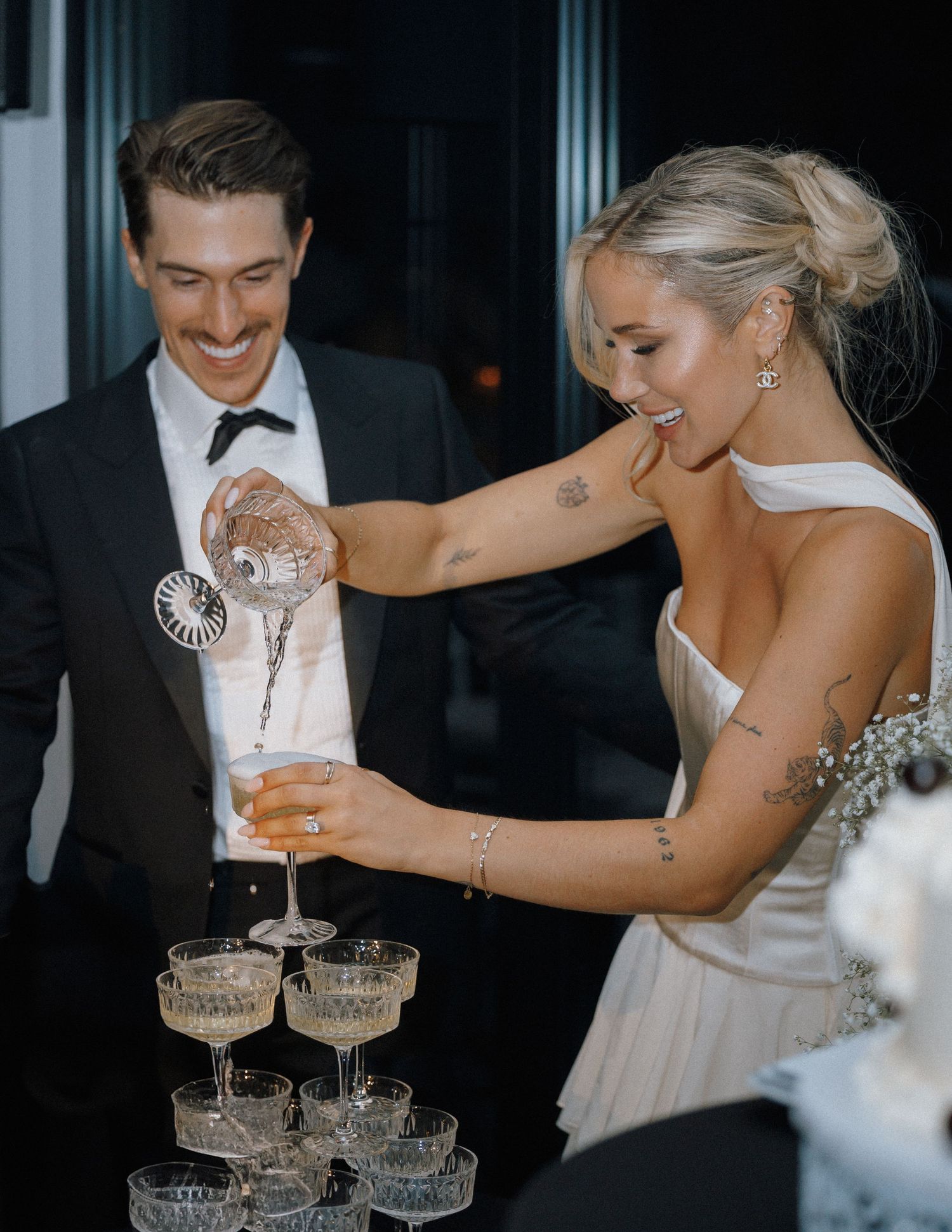 Wedding celebration with champagne tower and crystal glasses.