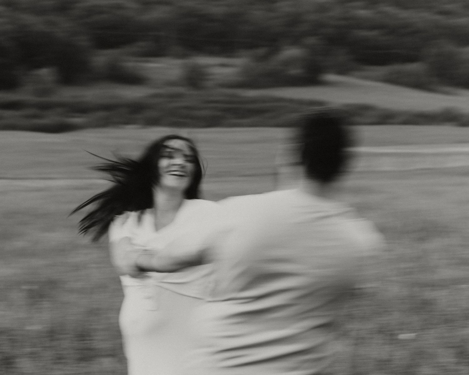 Motion blur photo sequence of couple dancing together in black and white.