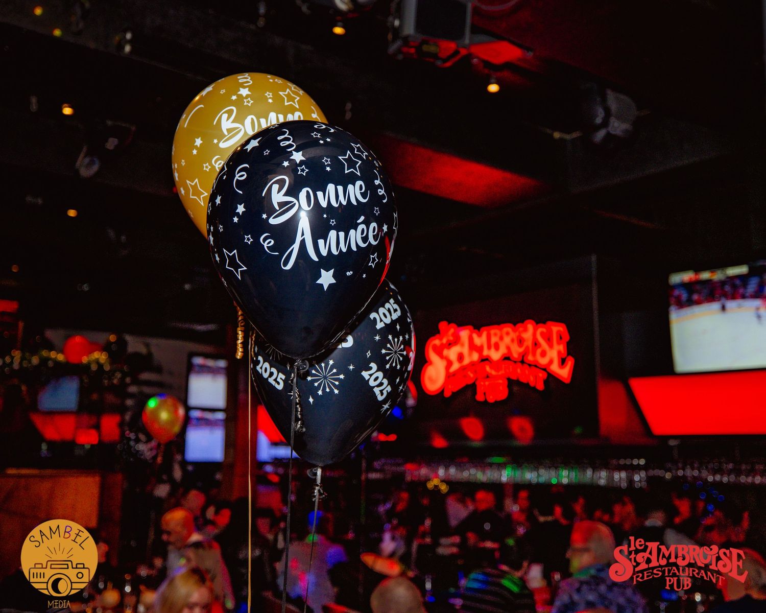 Illuminated golden balloons glowing in a dark nightclub atmosphere.