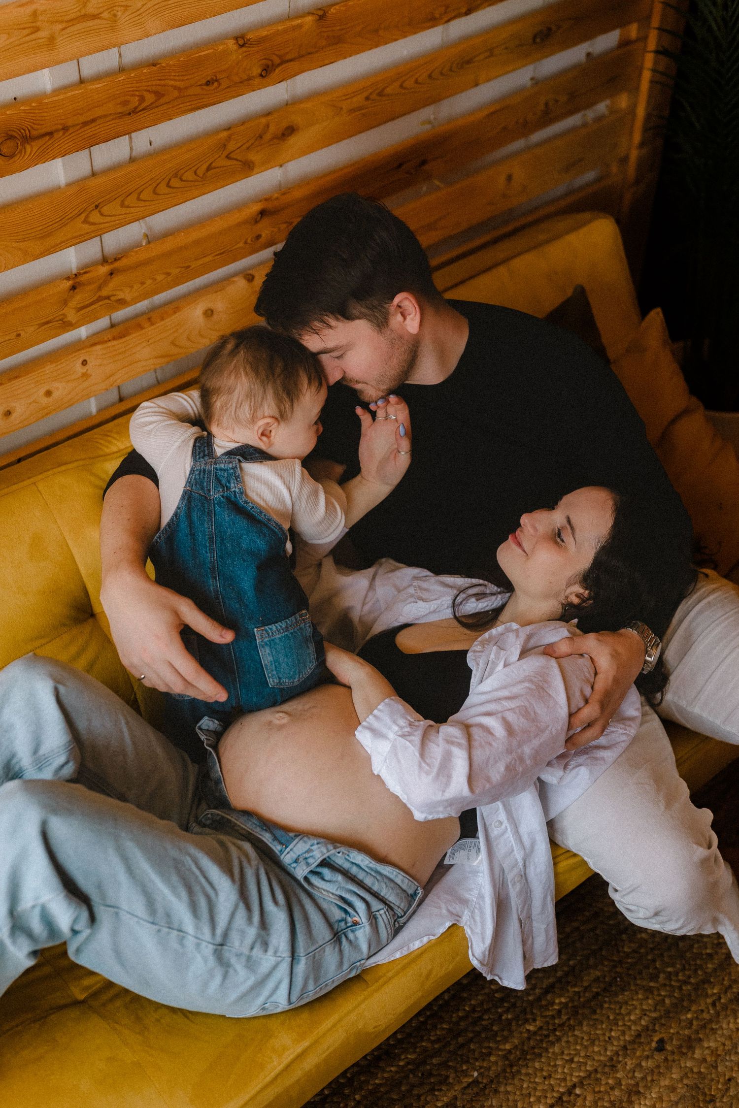 Couple sharing intimate moments on wooden furniture with rustic decor.
