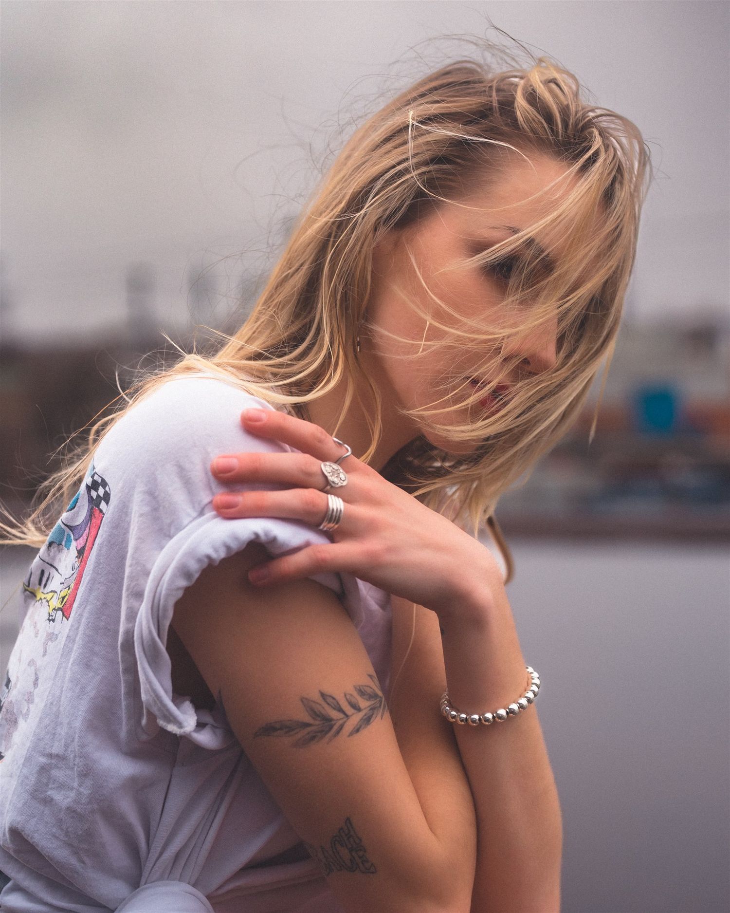 Casual outdoor photoshoot featuring relaxed poses in white t-shirt.
